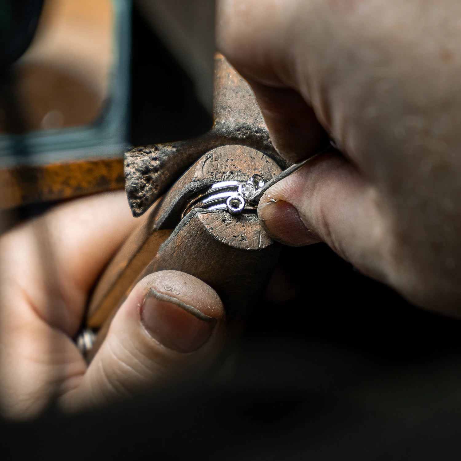 Close-up of a jeweller in York setting a gemstone into a ring by hand using precision tools
