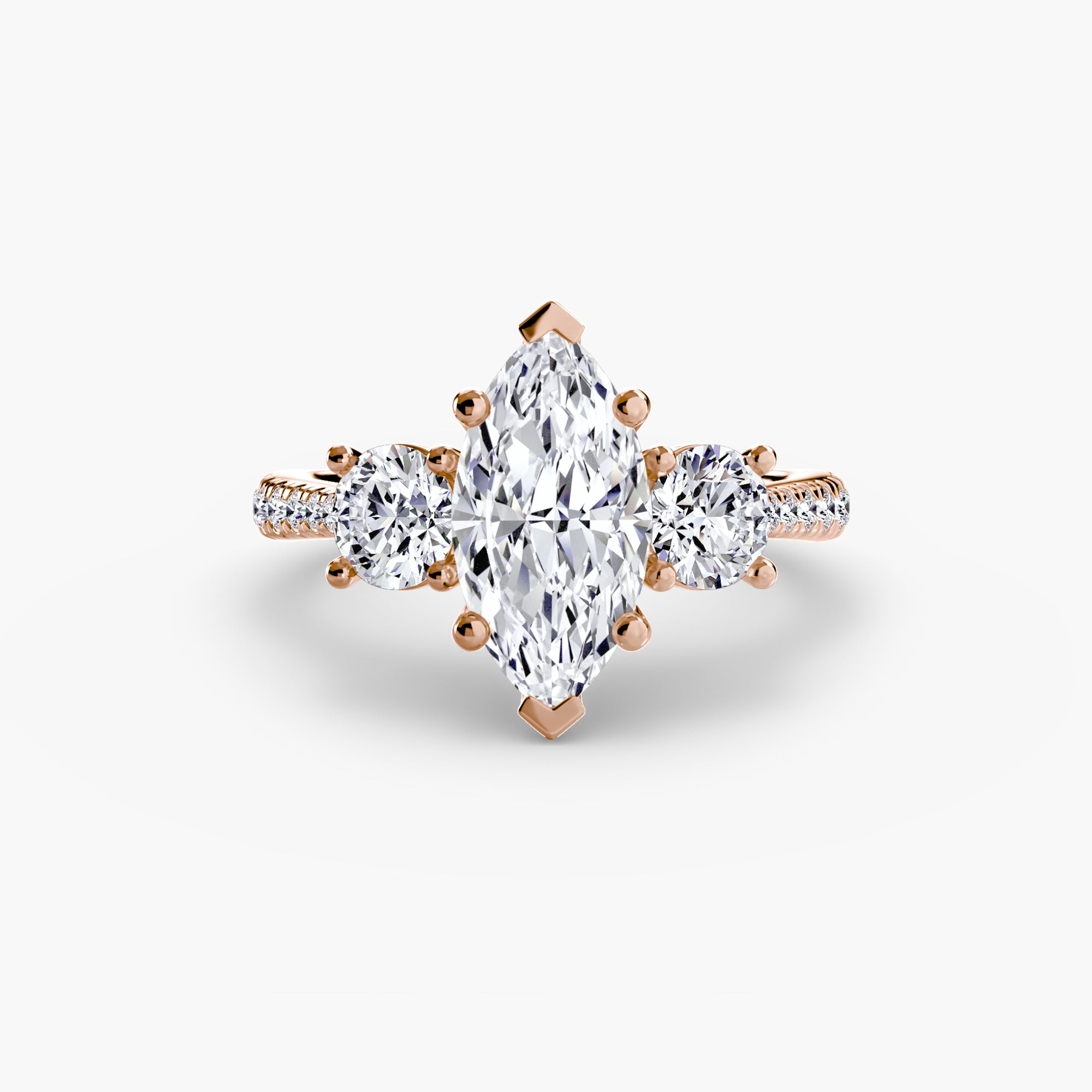 The MICHAEL ISAAC Three-Stone with Pavé Band ring in rose gold features a marquise center diamond, two round side diamonds, and sparkling pavé accents.