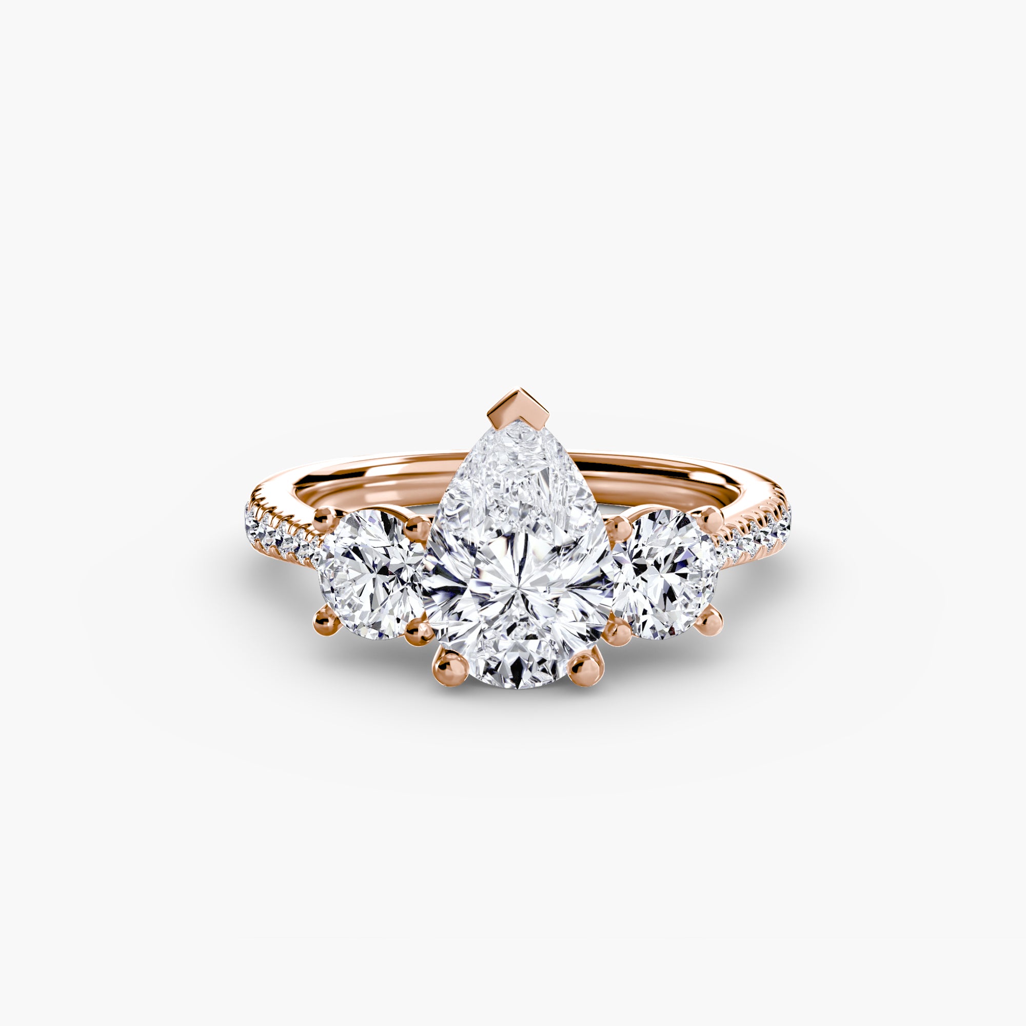 Experience elegance with MICHAEL ISAAC's Three-Stone with Pavé Band ring, showcasing a pear-shaped diamond centerpiece, two round side diamonds, and pavé-set diamonds along a stunning rose gold band.
