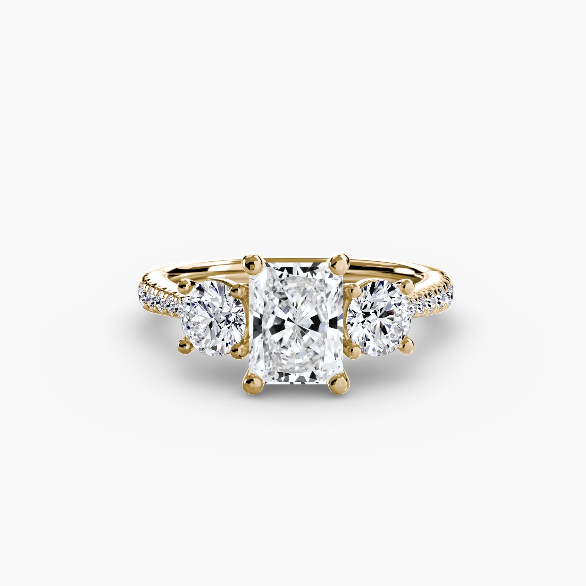 The MICHAEL ISAAC Three-Stone with Pavé Band ring showcases a large rectangular center diamond, two round side diamonds, and a pavé band embellished with shimmering stones.