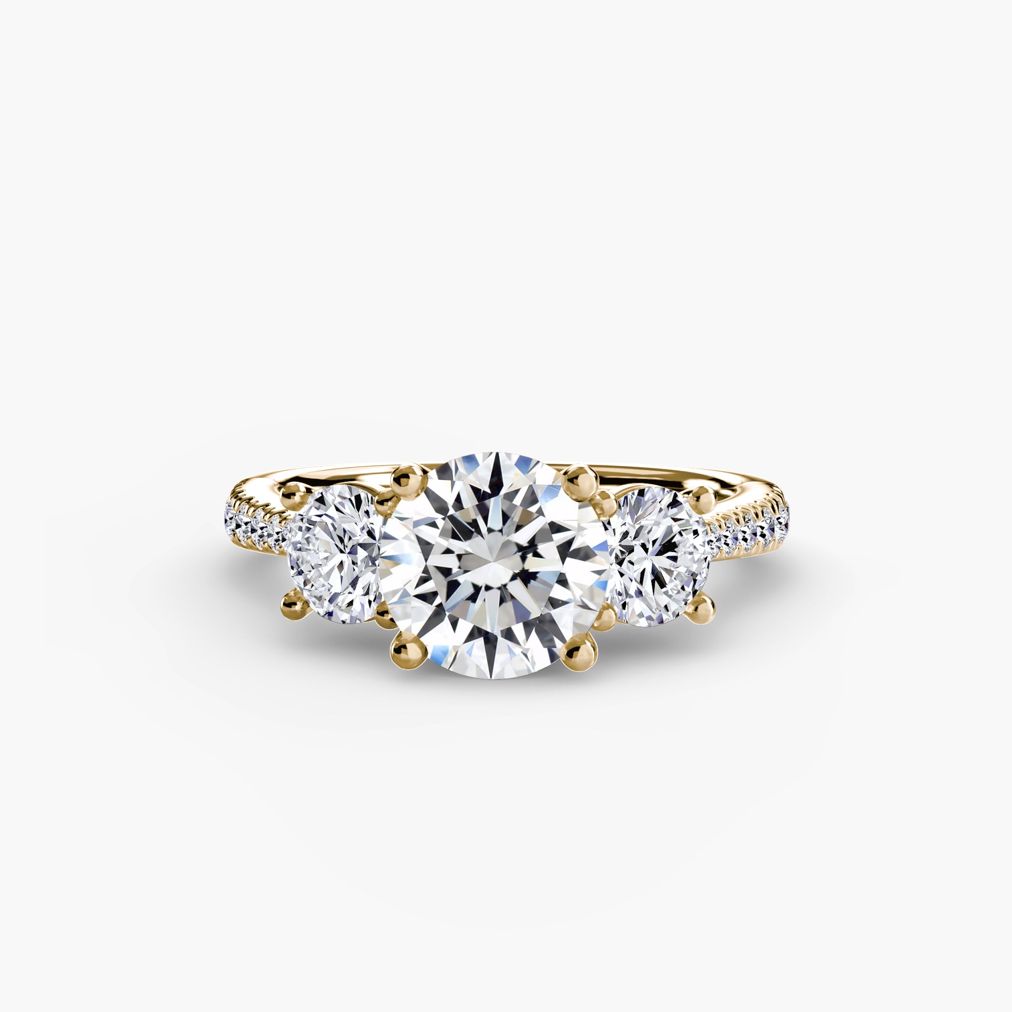 The MICHAEL ISAAC Three-Stone with Pavé Band is a gold ring showcasing a large round center diamond, two smaller side diamonds, and a pavé band sparkling with accent stones.