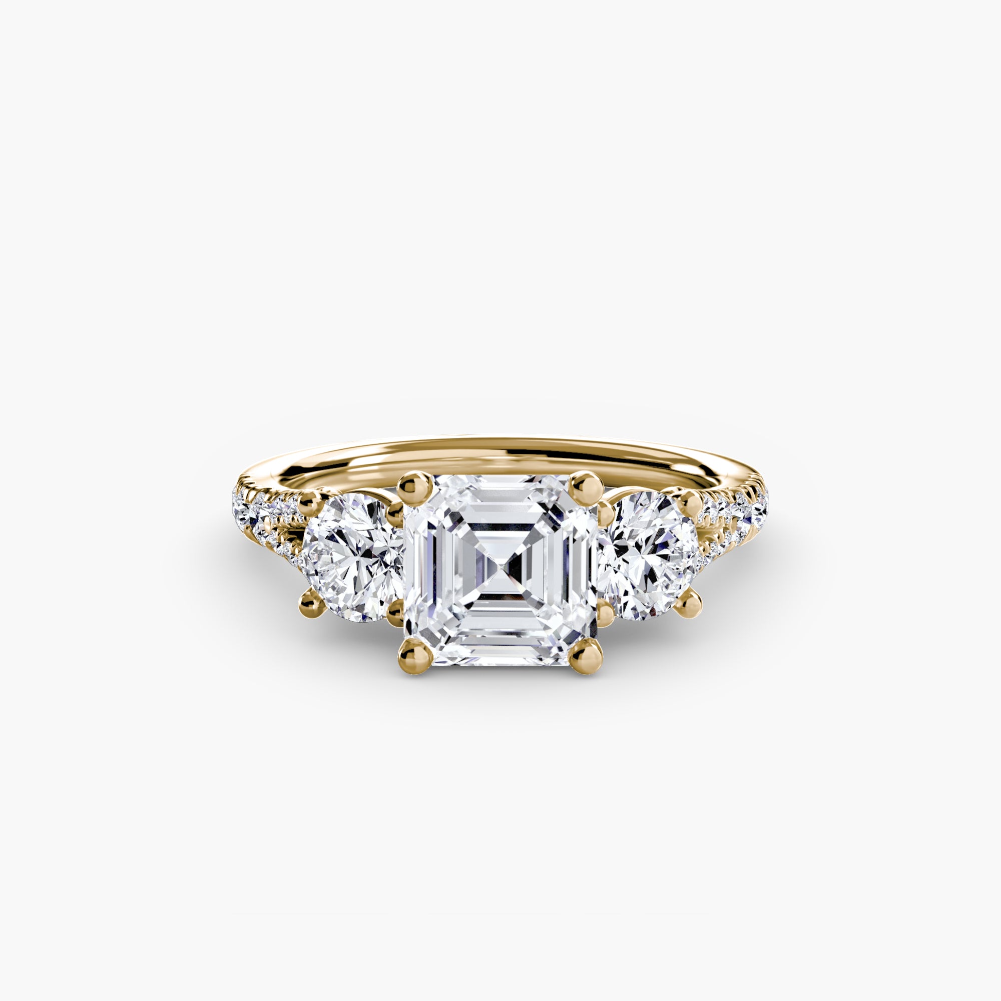 The MICHAEL ISAAC Three-Stone with Pavé Band 3 is a gold ring featuring a large square-cut center diamond, two smaller round diamonds on each side, and a polished gold band, shown against a plain white background.