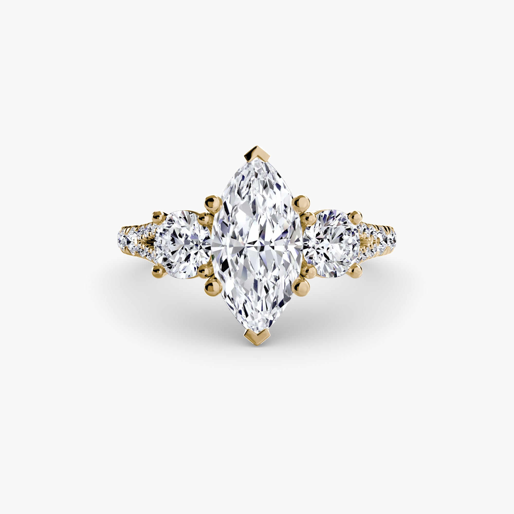 The MICHAEL ISAAC Three-Stone with Pavé Band 3 features a gold band with a marquise-cut center diamond, two round side diamonds, and sparkling accent diamonds on the pavé band.