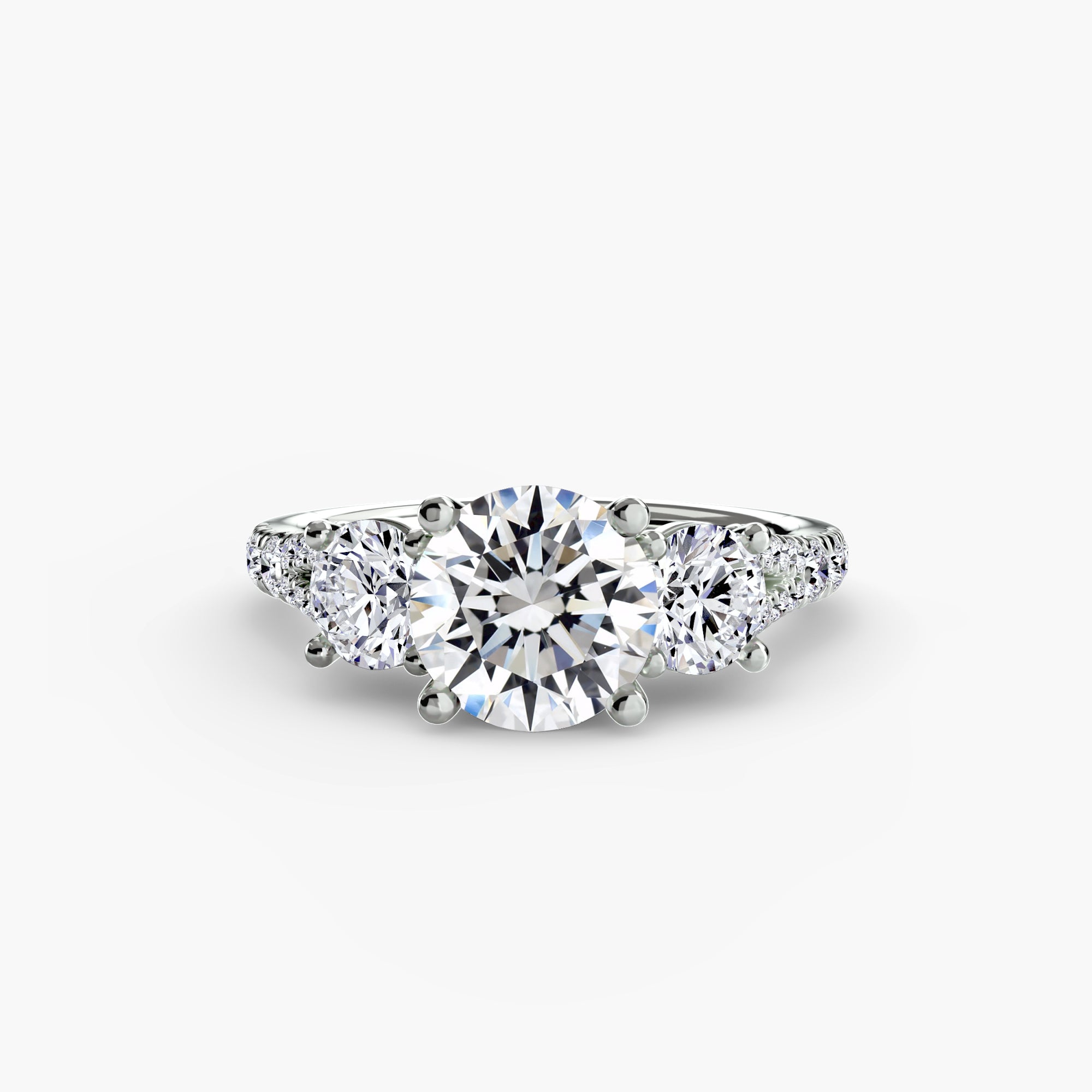 The Three-Stone with Pavé Band 3 by MICHAEL ISAAC is an elegant silver ring featuring a large round center diamond and two smaller round diamonds on each side, beautifully displayed against a plain white background.