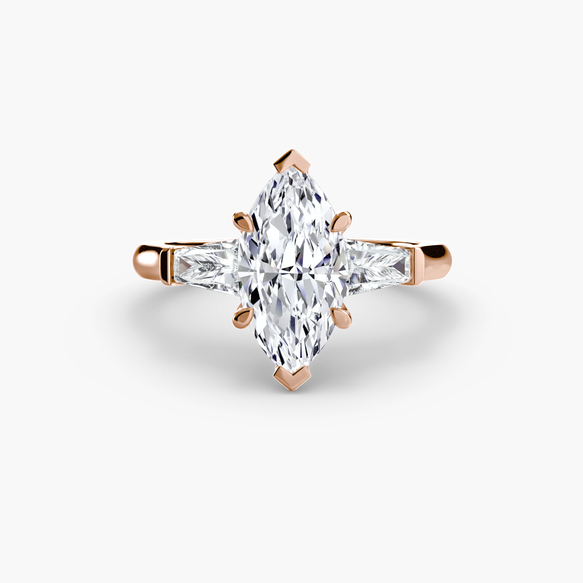 The MICHAEL ISAAC Three-Stone Ring features a rose gold band with a central marquise-cut diamond and two baguette side stones, shown against a plain white background.