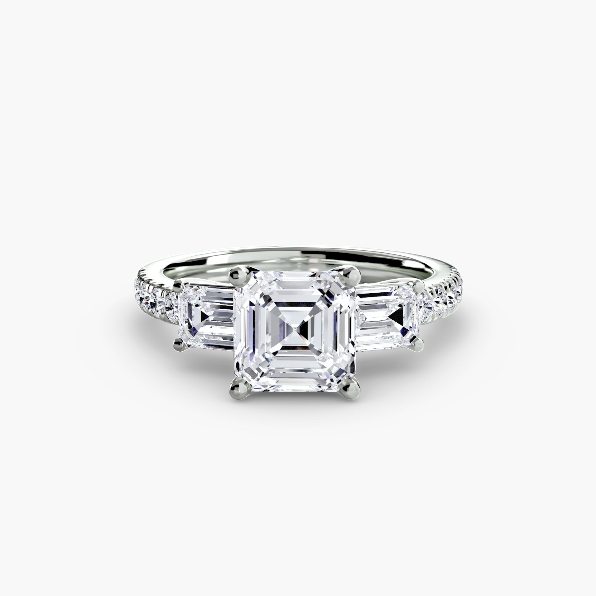 The MICHAEL ISAAC Three-Stone Ring with Pavé Band 4 features a large Asscher-cut diamond center, baguette-cut side diamonds, and sparkling pavé-set round diamonds on a white gold or platinum band.