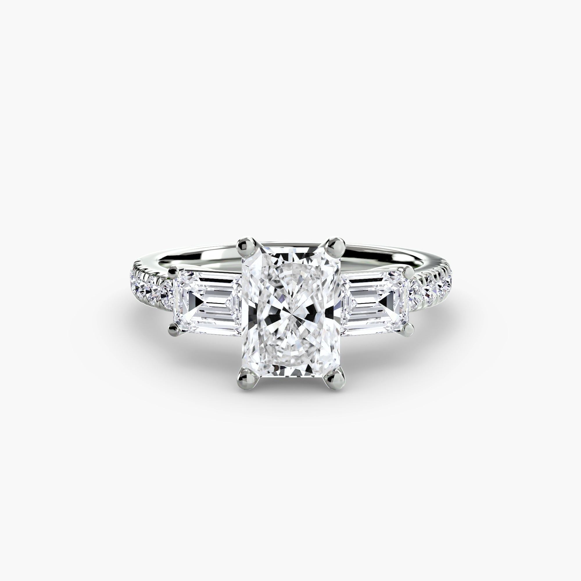 The MICHAEL ISAAC Three-Stone Ring with Pavé Band 4 features a cushion-cut diamond center, two baguette-cut side diamonds, and round pavé diamonds on a platinum band, displayed on a white background.