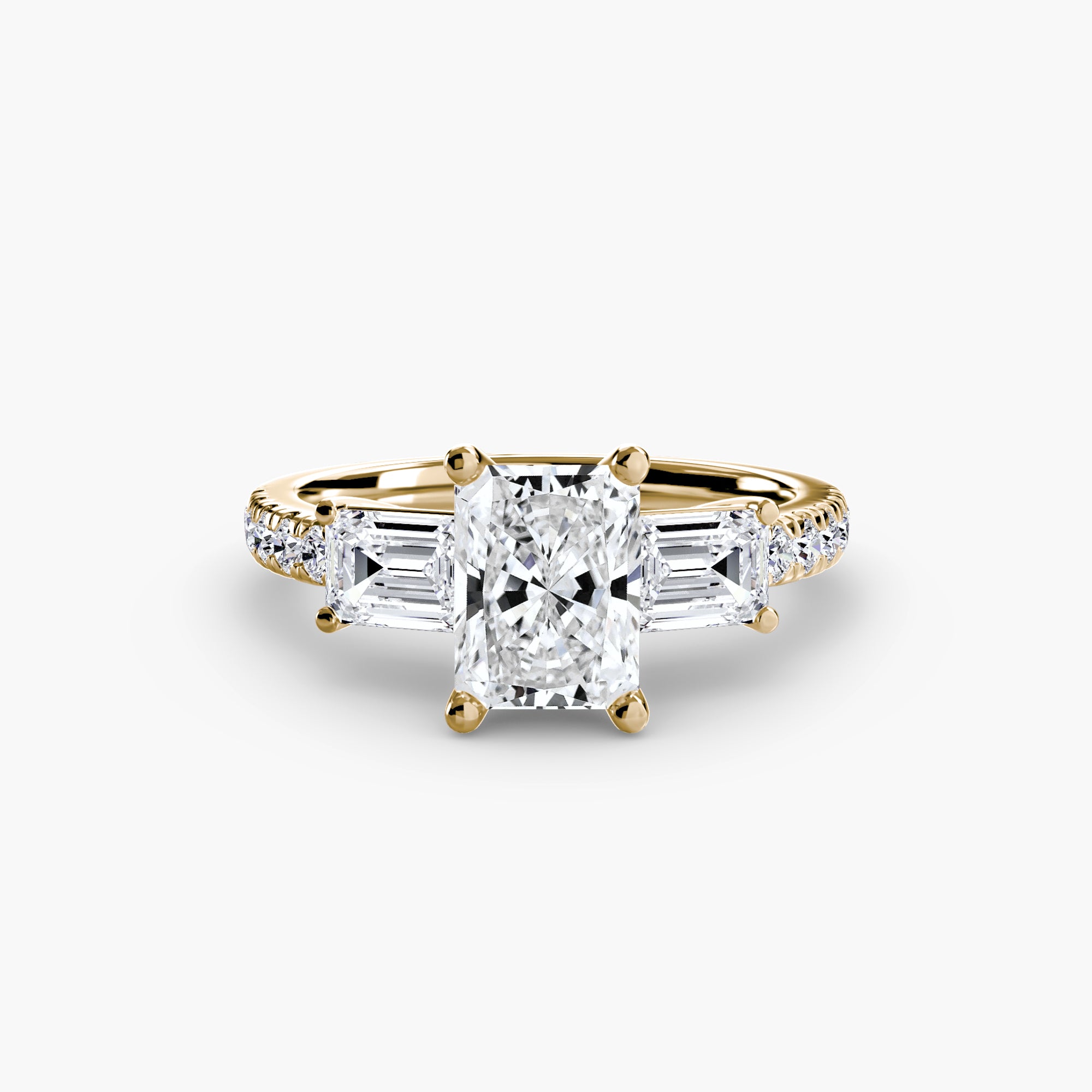 The Three-Stone Ring with Pavé Band 4 by MICHAEL ISAAC features a radiant-cut center diamond, trapezoid side diamonds, and small round diamonds set along the pavé band for added brilliance.