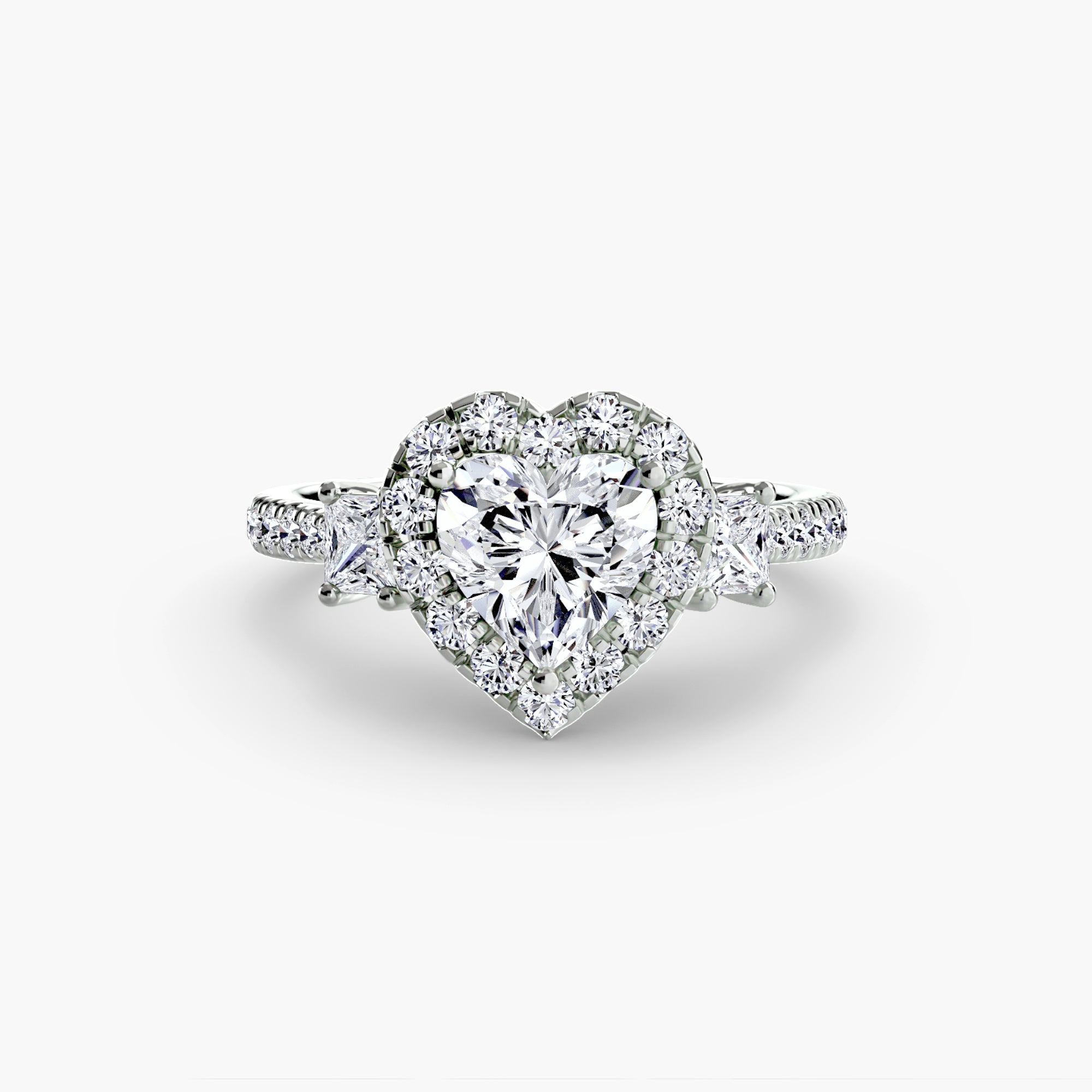 The MICHAEL ISAAC Three-Stone Ring with Halo 2 features a heart-shaped diamond, radiant halo of small round diamonds, and a white metal band with diamond accents for a modern look.