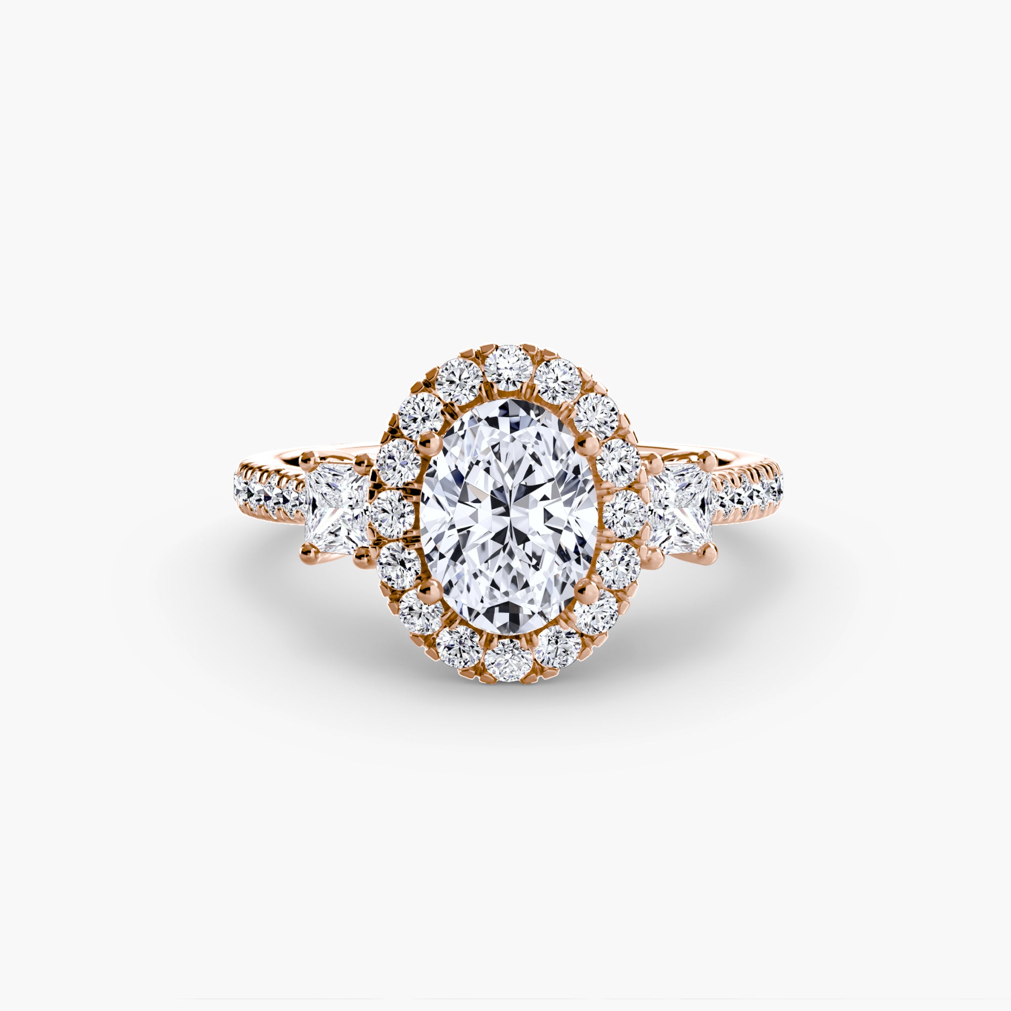 The MICHAEL ISAAC Three-Stone Ring with Halo 2 features an oval center diamond with a radiant halo, triangle-cut side diamonds, and a sparkling diamond band in rose gold.
