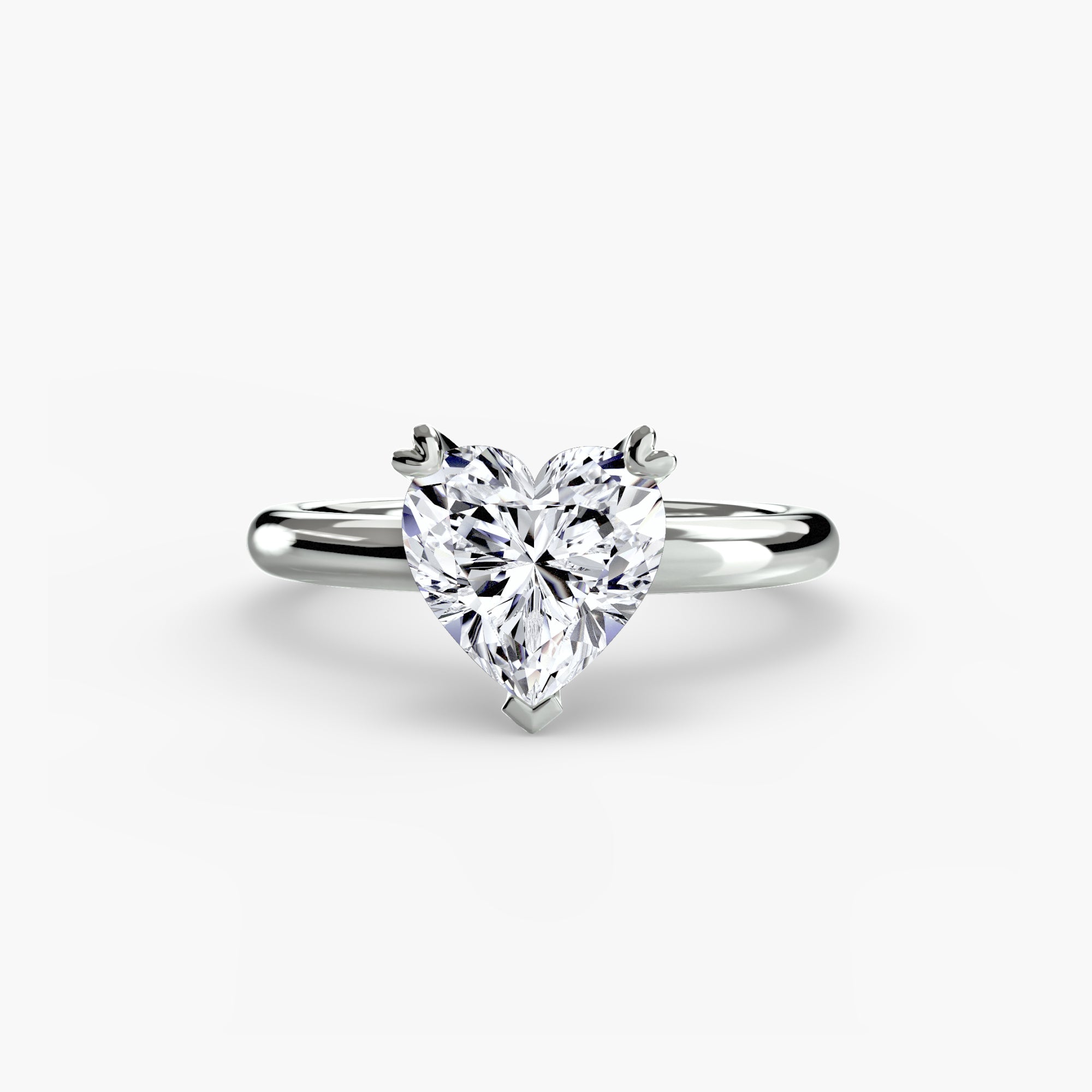 The MICHAEL ISAAC Solitaire ring 2 is a silver ring featuring a heart-shaped diamond in a classic setting with an elegant, simple band, shown on a white background.