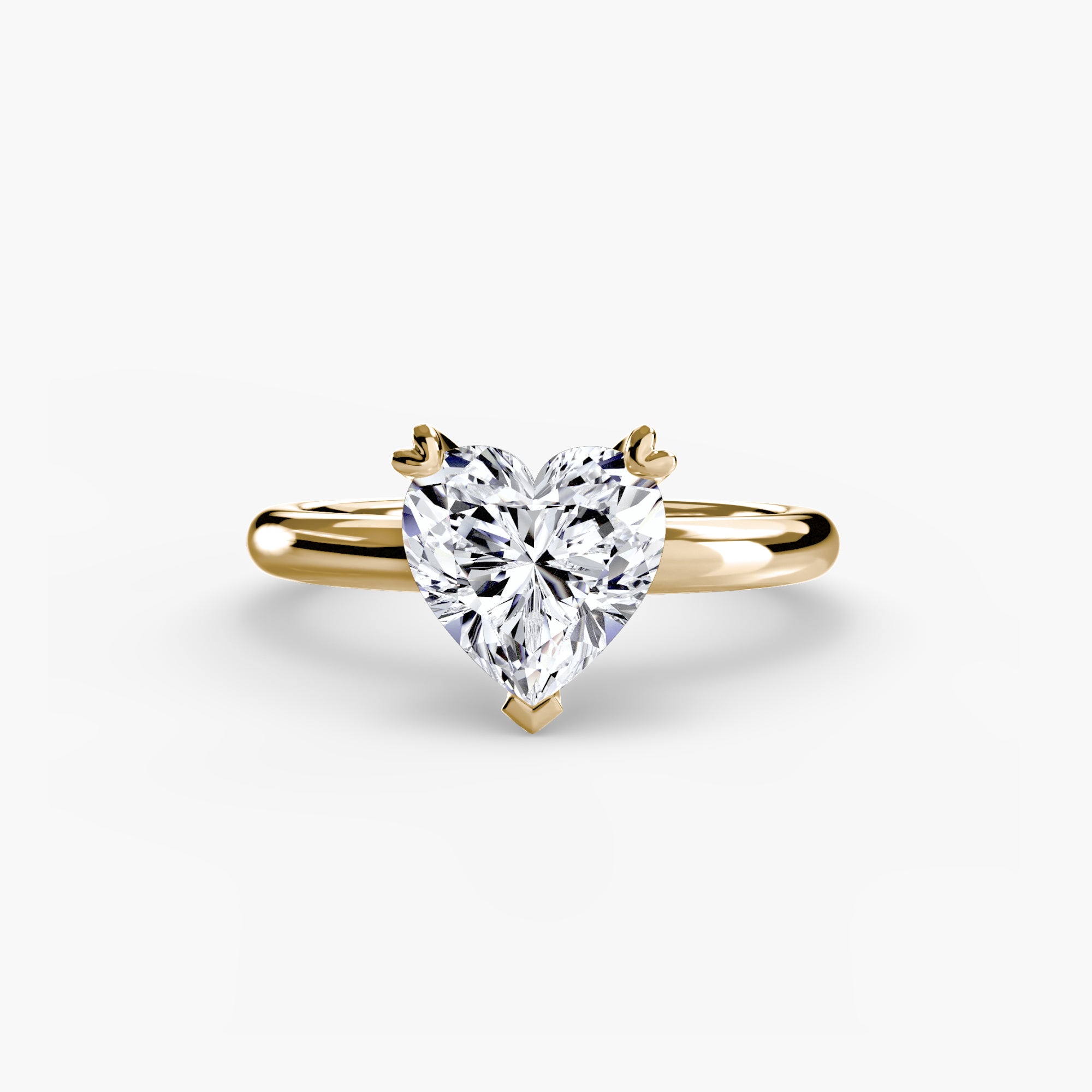 The MICHAEL ISAAC Solitaire Ring 2 is a gold ring featuring a heart-shaped diamond in a classic setting on a simple, elegant band, shown against a plain white background.