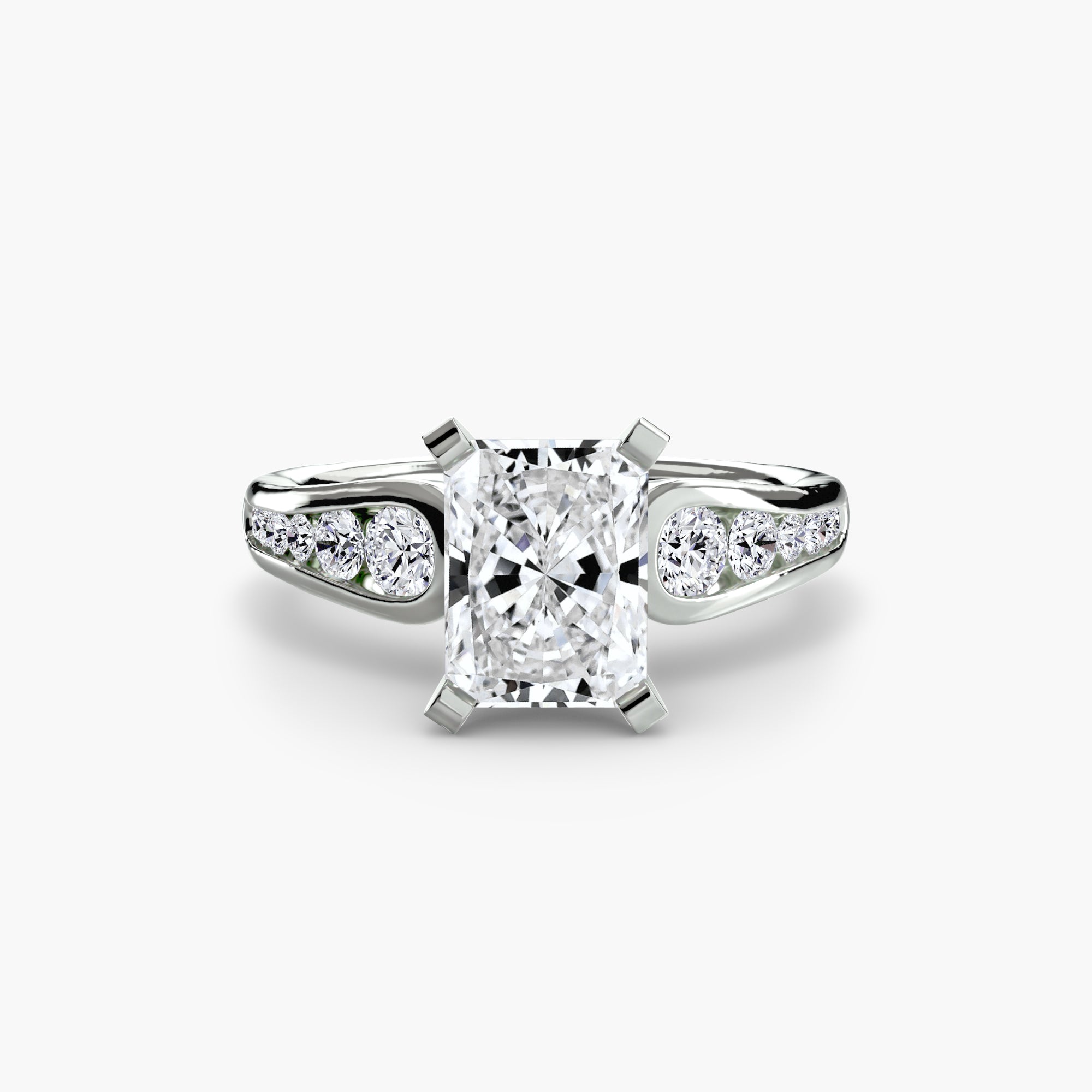 The Solitaire with Pavé 2 by MICHAEL ISAAC is a white gold ring featuring a radiant-cut center diamond in four prongs, accented by pavé-set round diamonds on the band for elegant everyday luxury.