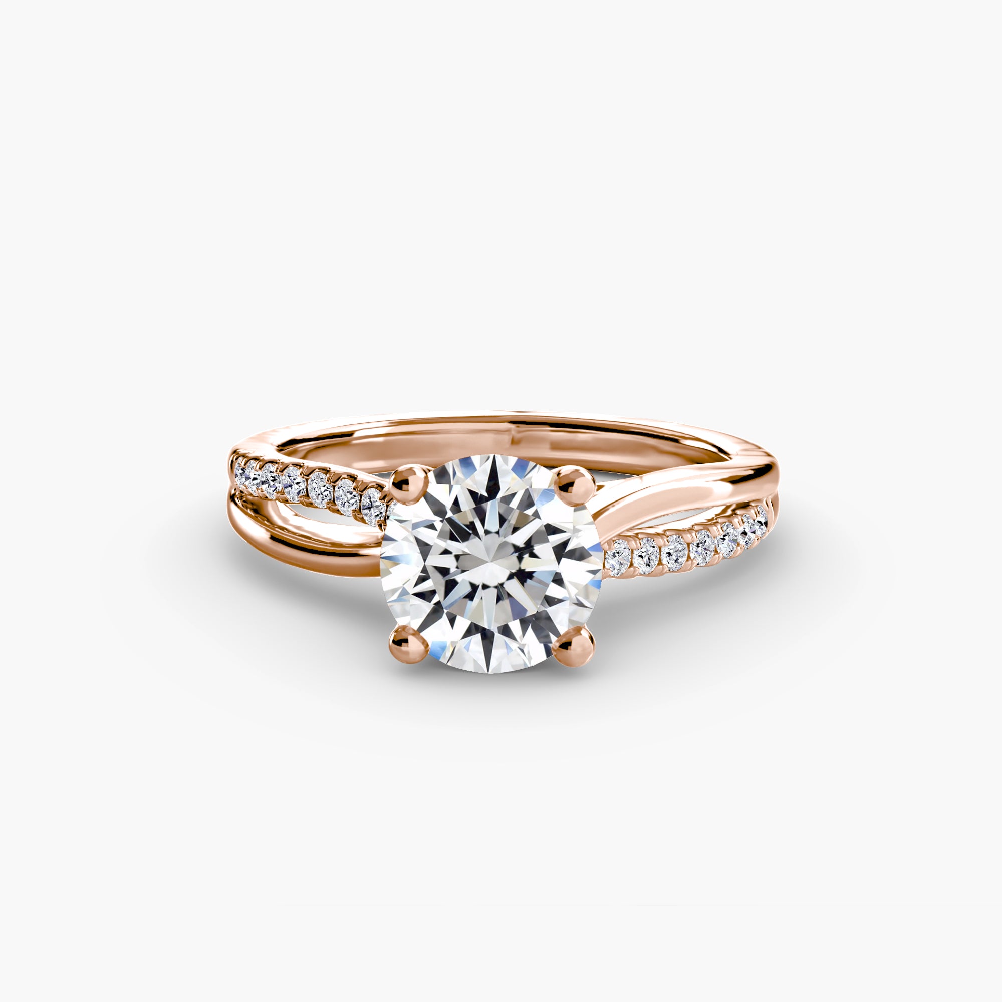 The Split Shank Pavé Solitaire by MICHAEL ISAAC is a rose gold ring with a large round diamond in a four-prong setting and pavé-set accent diamonds along a split shank band, delivering elegant everyday luxury against a white background.