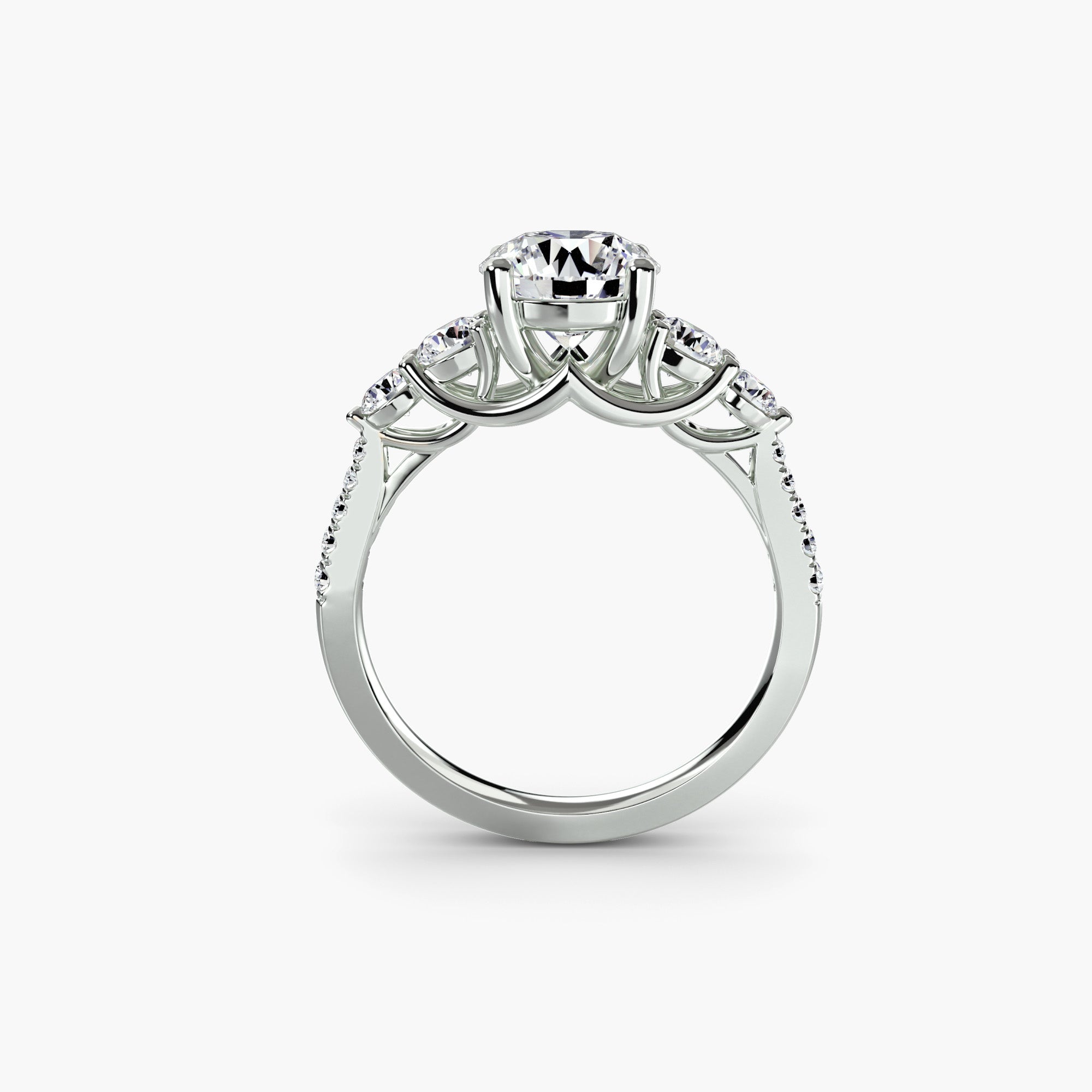 The MICHAEL ISAAC Five Stone Ring with Pavé Band features a large round center diamond flanked by smaller diamonds and pavé gems along the platinum band, displayed upright against a white background.