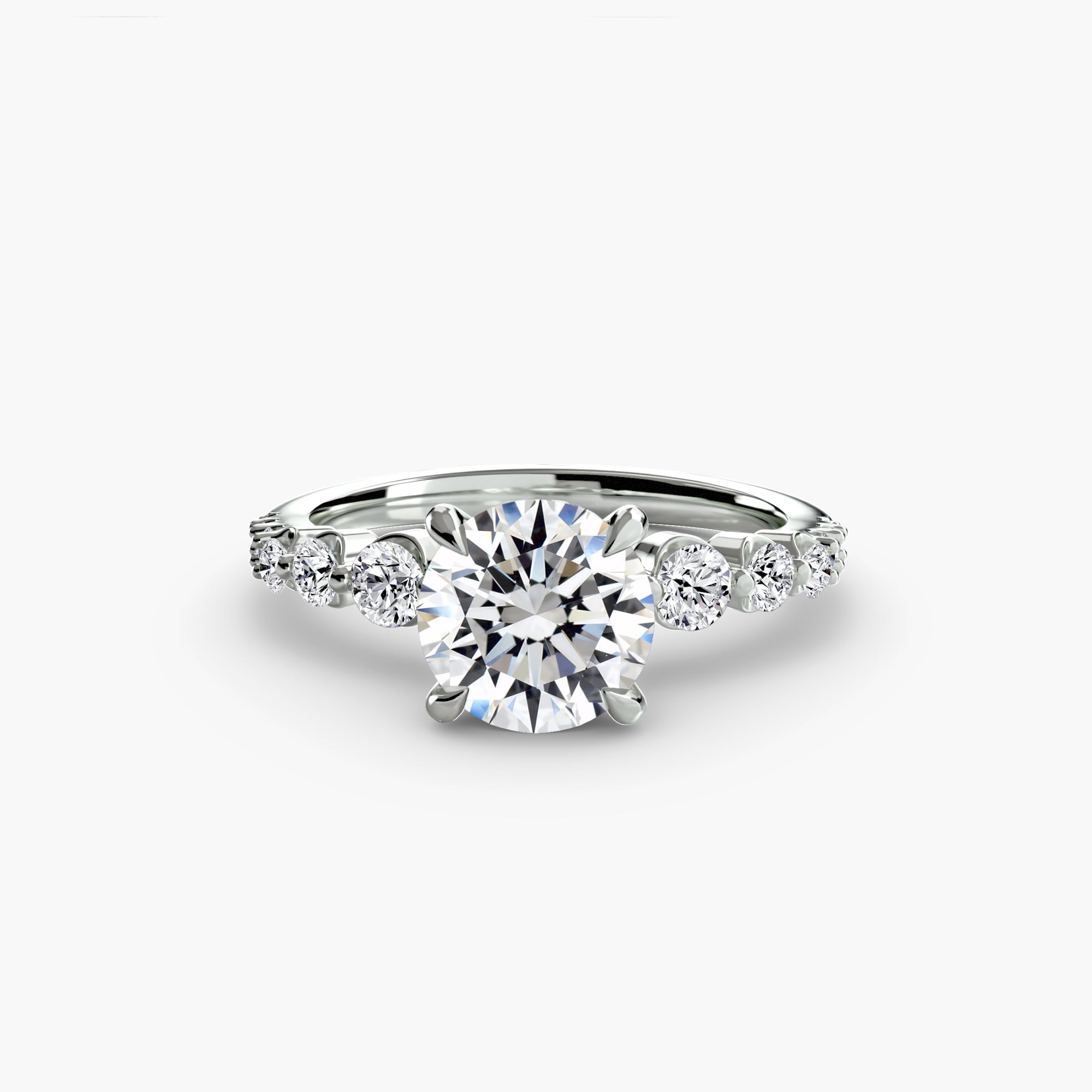 The Cascade Diamond Ring by MICHAEL ISAAC features a large round-cut center stone with three smaller side stones on each side, elegantly set against a plain white background.