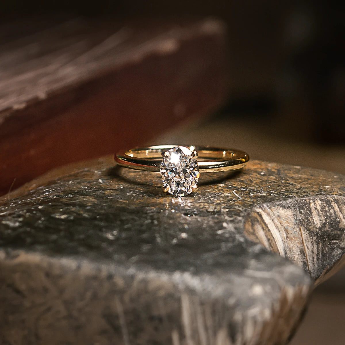 Gold ring with a diamond on a textured stone surface #metal_gold