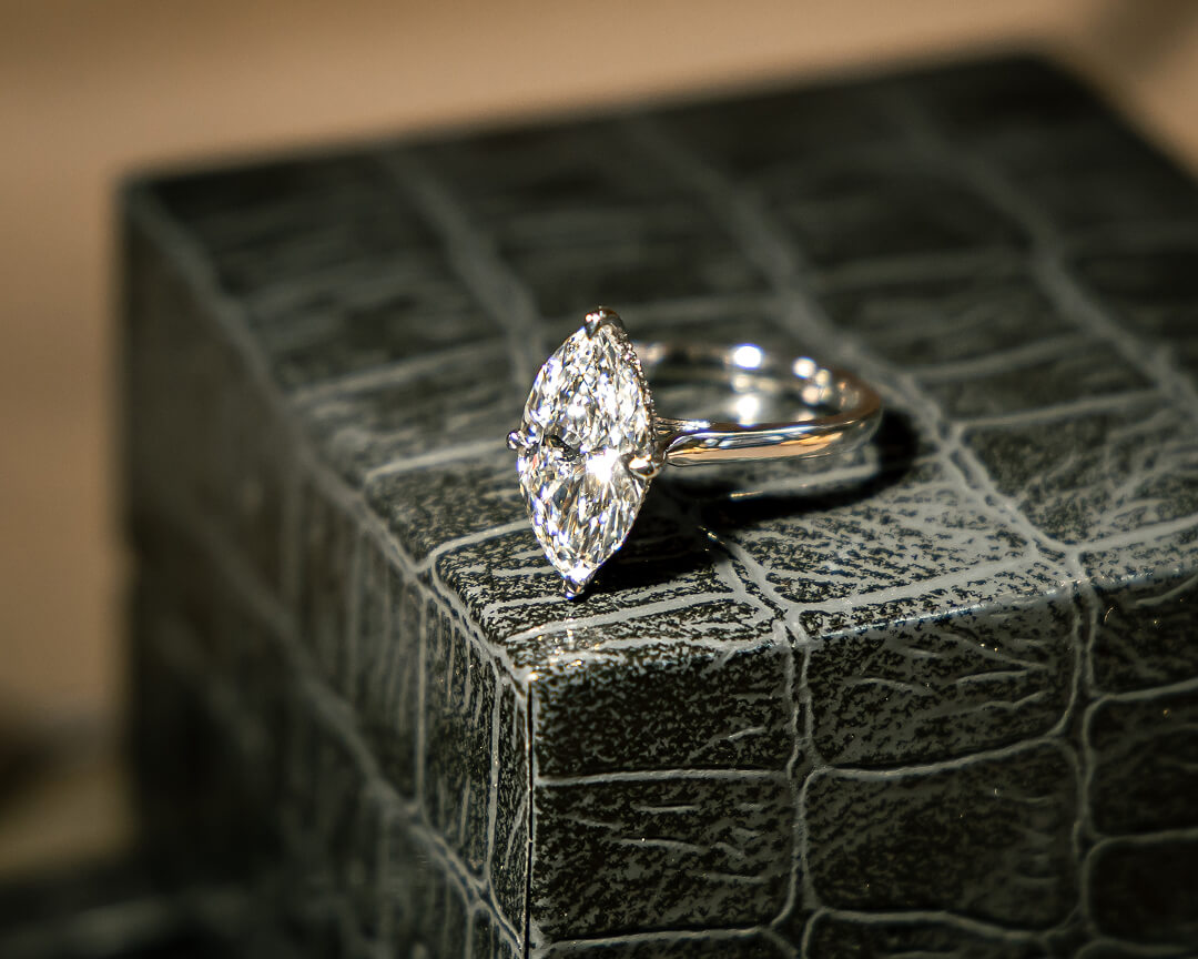 Couple admiring bespoke engagement ring from Michael Isaac