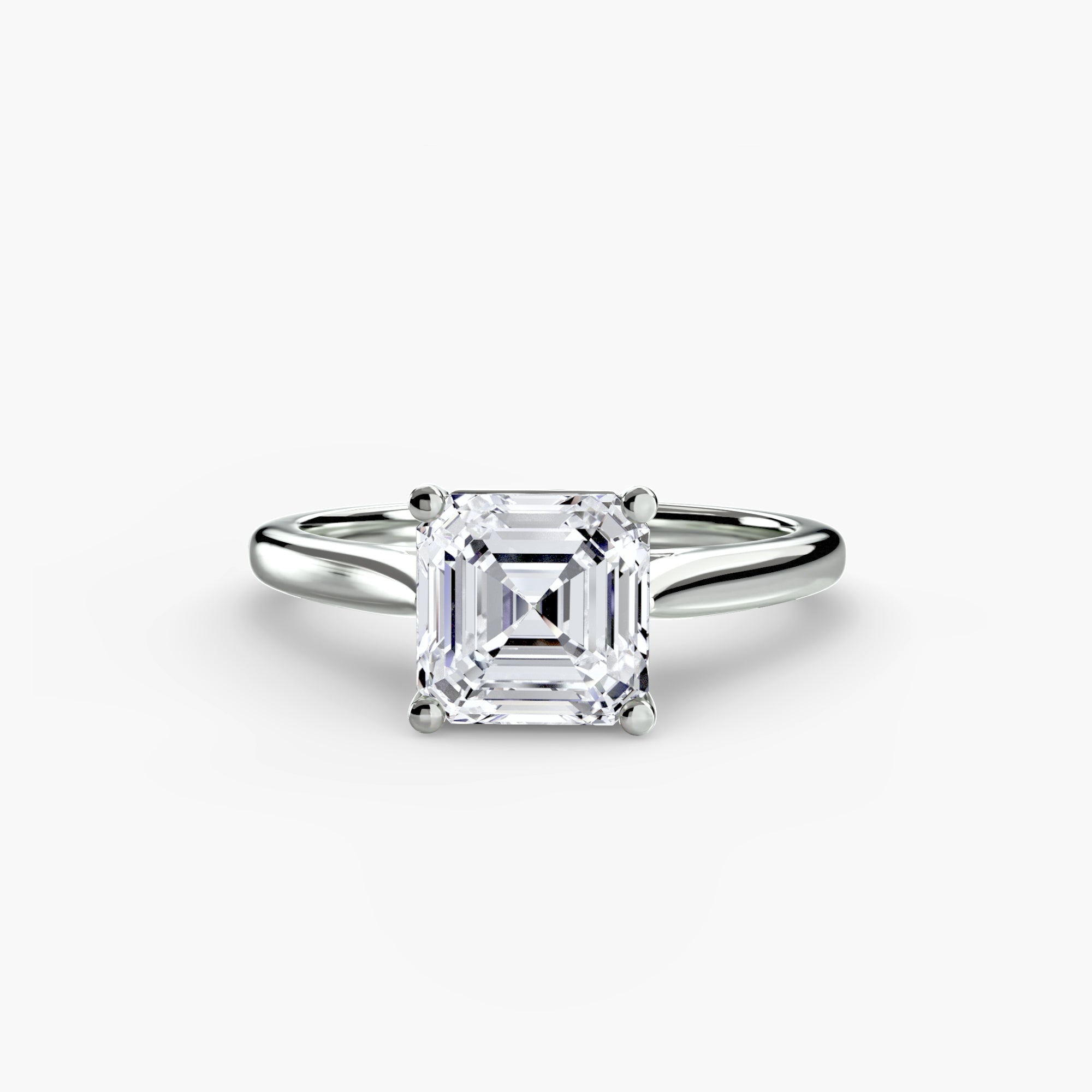 The MICHAEL ISAAC Solitaire ring 1 is a silver solitaire with a radiant, rectangular diamond featuring cut corners in a minimalist four-prong setting, shown against a plain white background.
