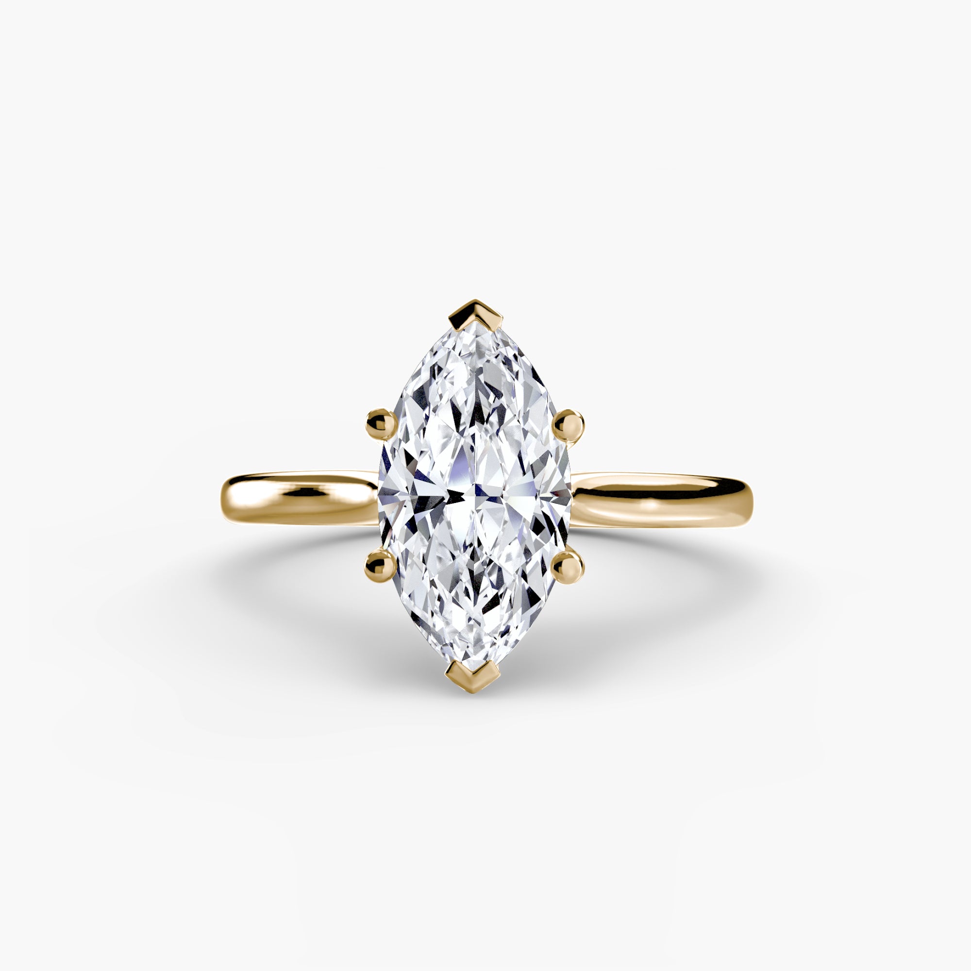 The MICHAEL ISAAC Solitaire ring 1 showcases a marquise-cut diamond set vertically in a classic four-prong gold solitaire setting, displayed against a plain white background.