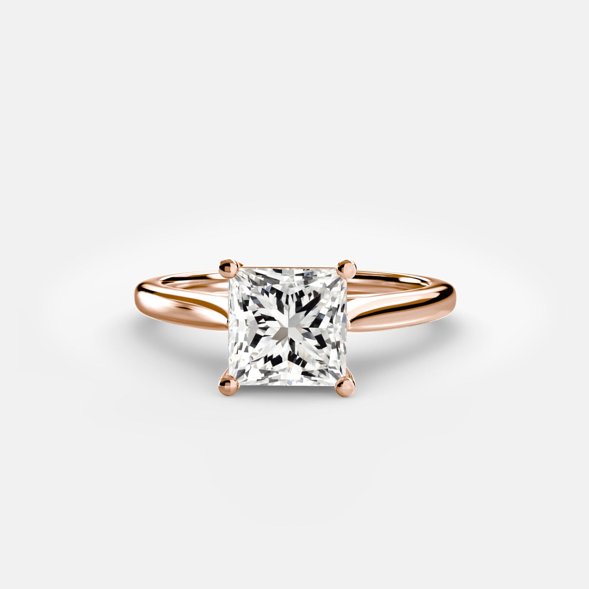 The MICHAEL ISAAC Solitaire ring 1 is a rose gold solitaire featuring a square clear diamond in a classic four-prong setting, shown against a plain white background.