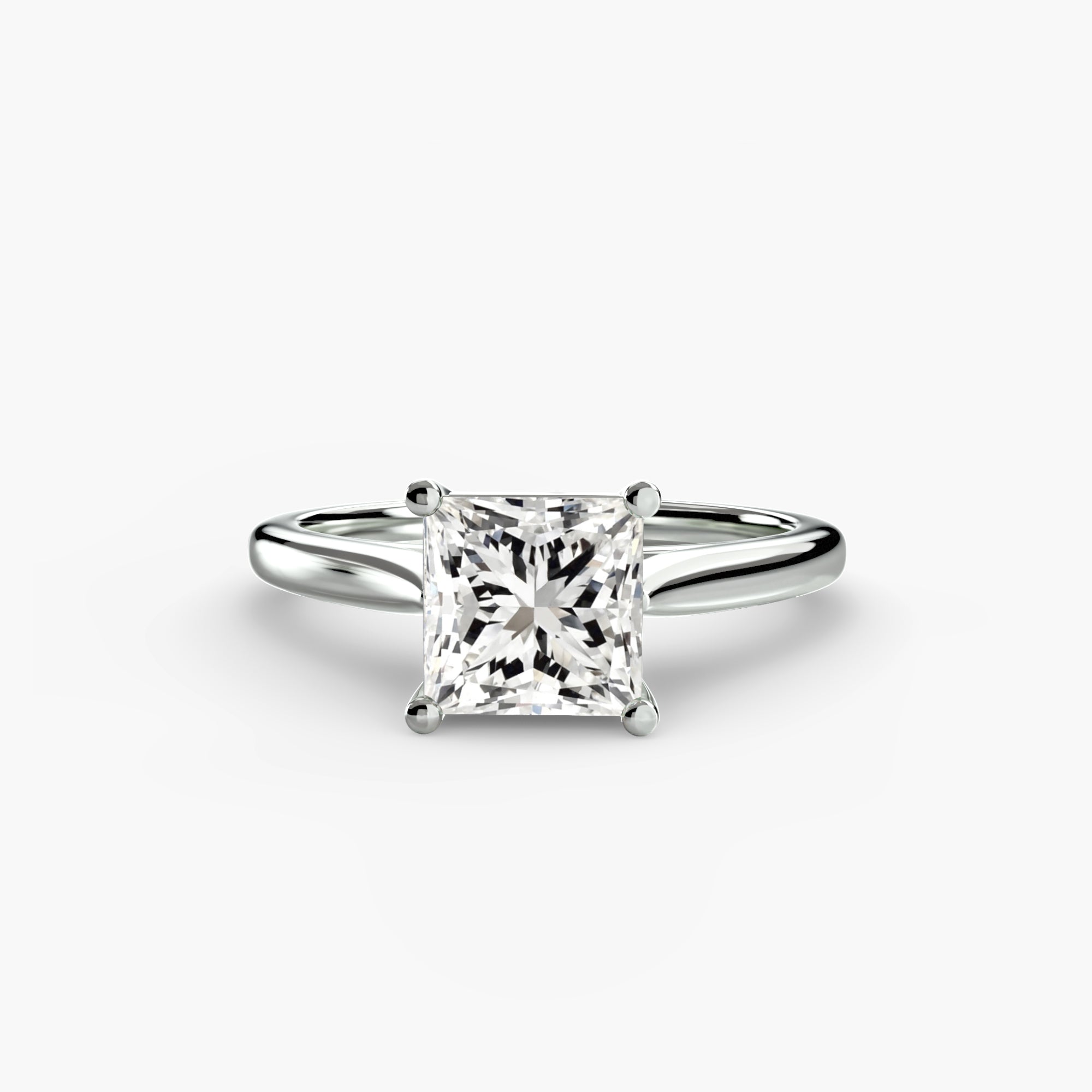 The Solitaire ring 1 by MICHAEL ISAAC is a minimalist solitaire ring with a princess-cut diamond in a classic four-prong white metal band, displayed on a plain white background.