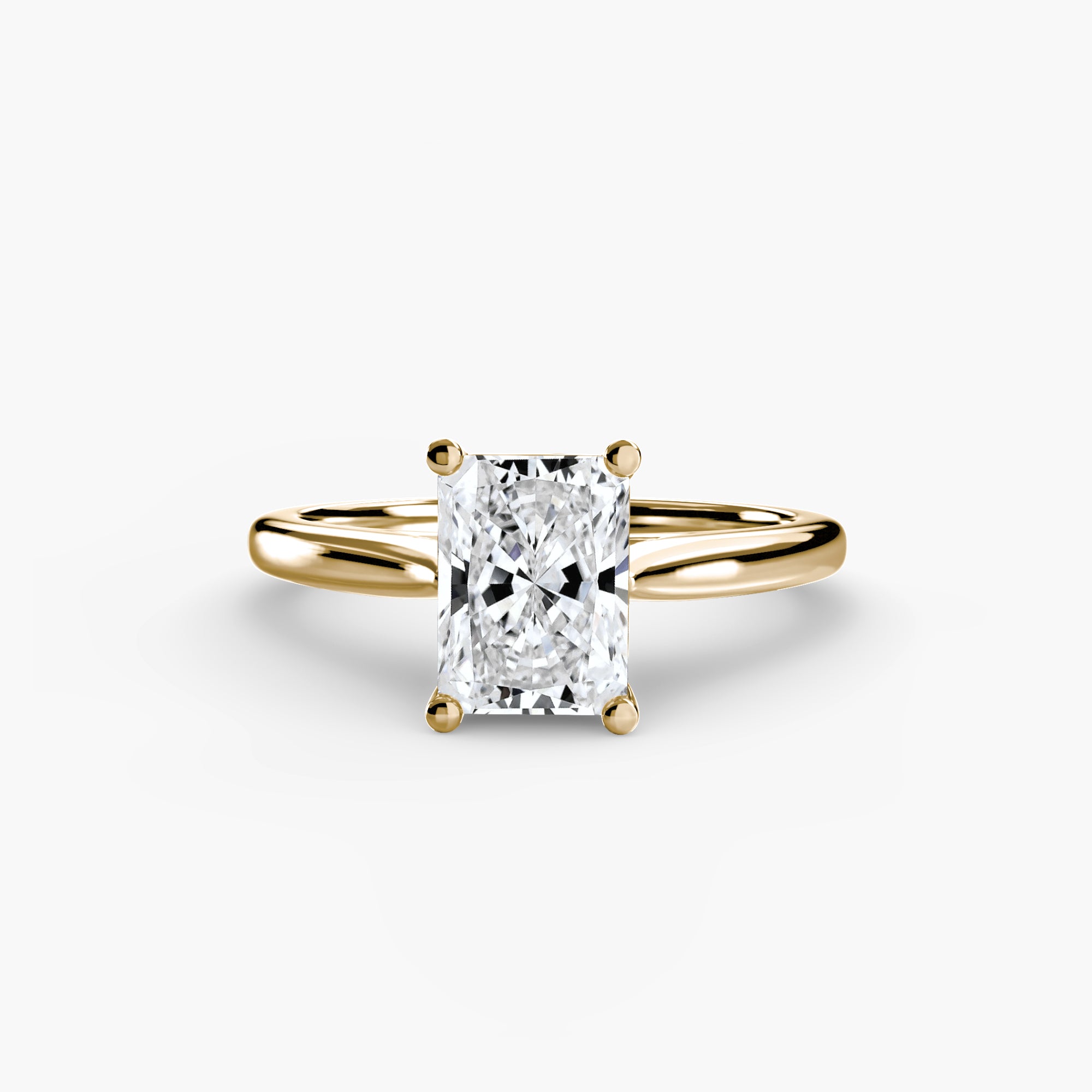 The MICHAEL ISAAC Solitaire ring 1 is a gold minimalist ring with a radiant-cut rectangular diamond solitaire in a classic four-prong setting, shown on a plain white background.