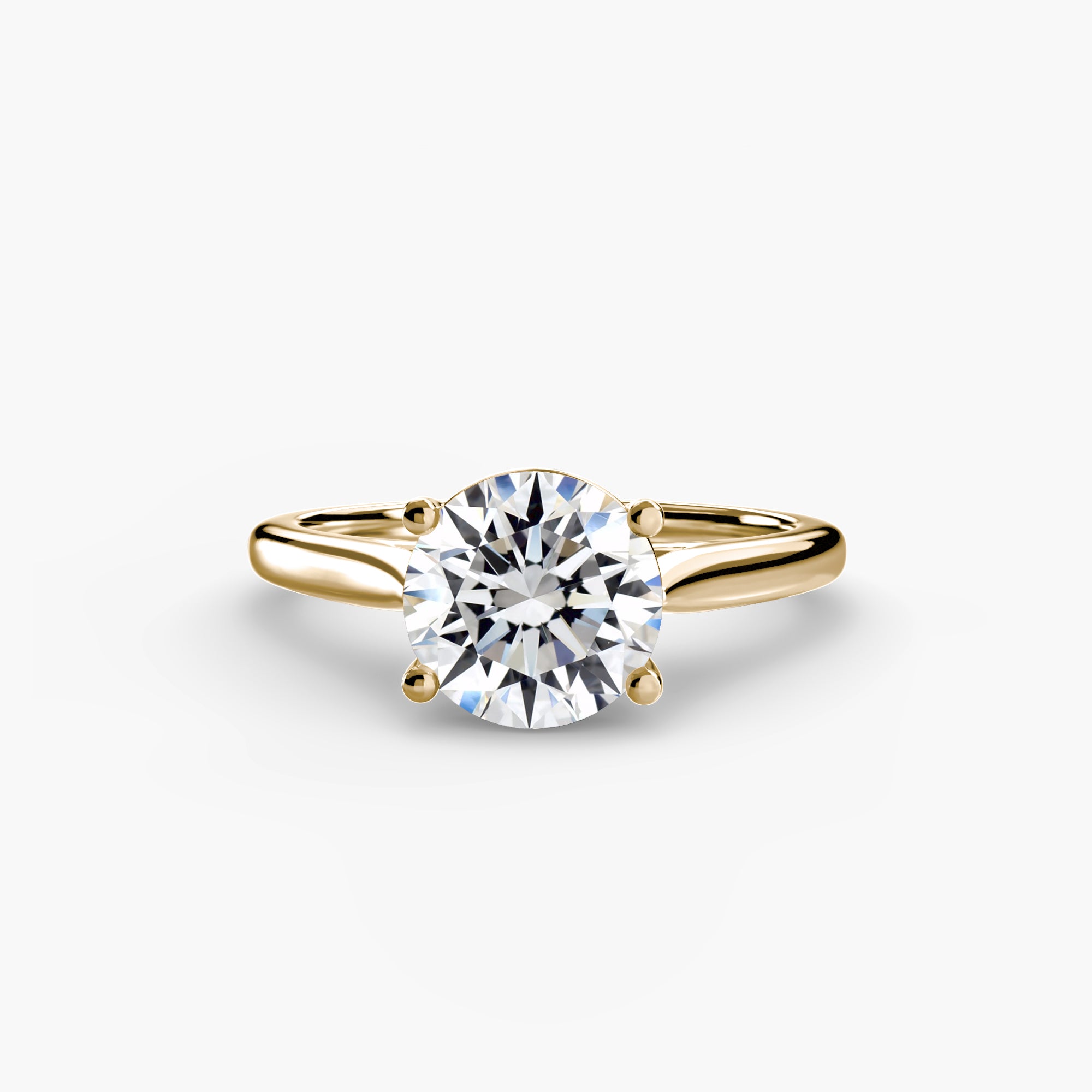 The MICHAEL ISAAC Solitaire ring 1 is a gold solitaire ring with a thin band and a large round diamond in a classic four-prong setting, shown on a plain white background.