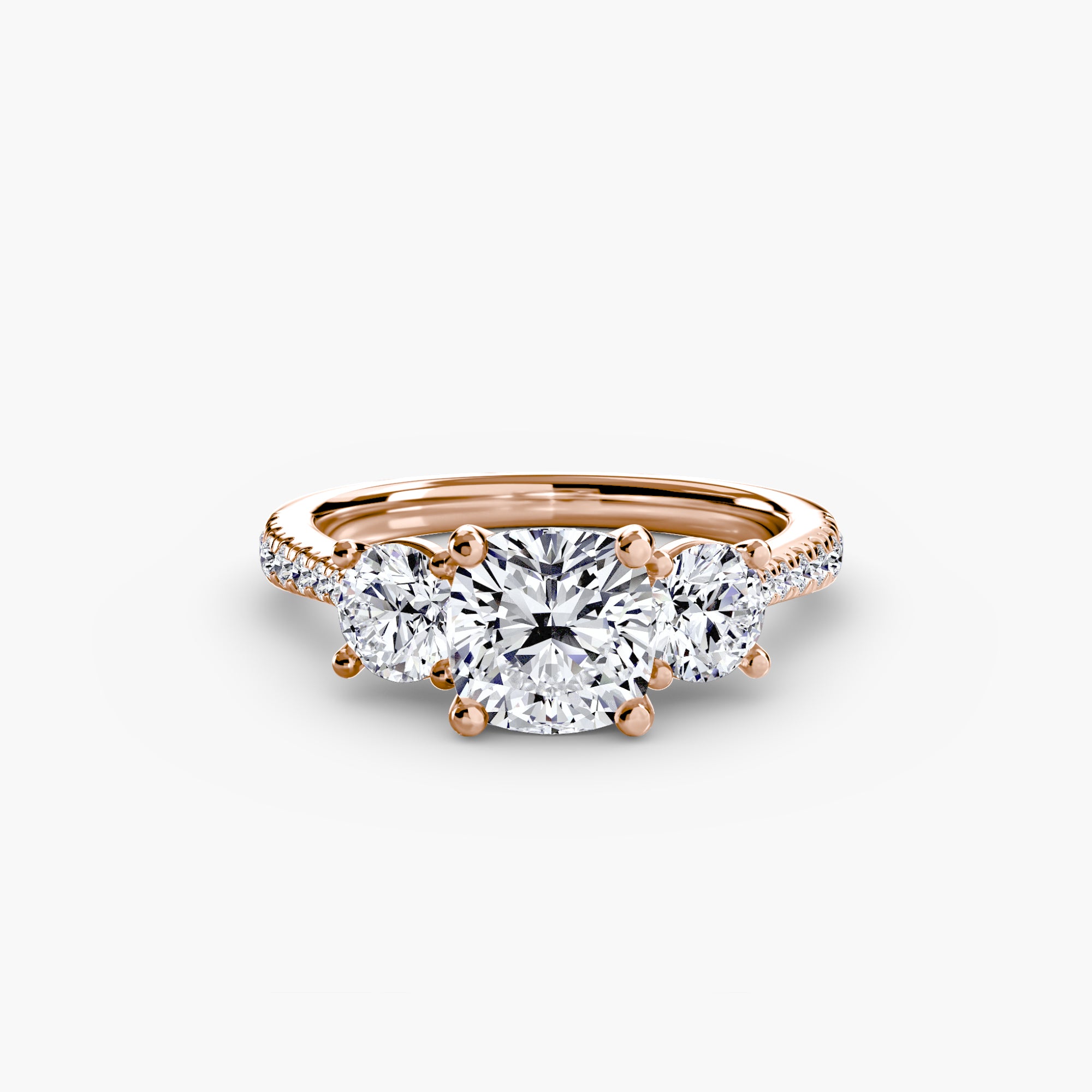 The MICHAEL ISAAC Three-Stone with Pavé Band ring showcases a large round center diamond between two smaller stones, accented by sparkling pavé along an elegant rose gold band.
