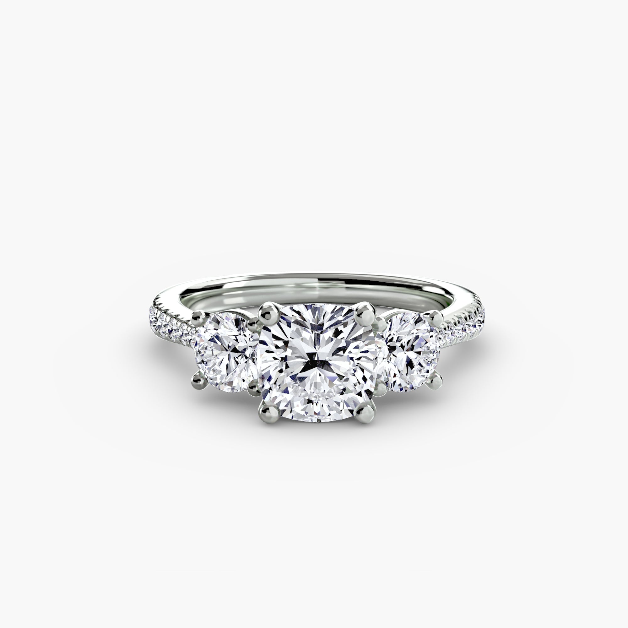 The Three-Stone with Pavé Band ring by MICHAEL ISAAC features a large round center diamond, two side diamonds, and pavé band accents, crafted in platinum and shown on a plain white background.
