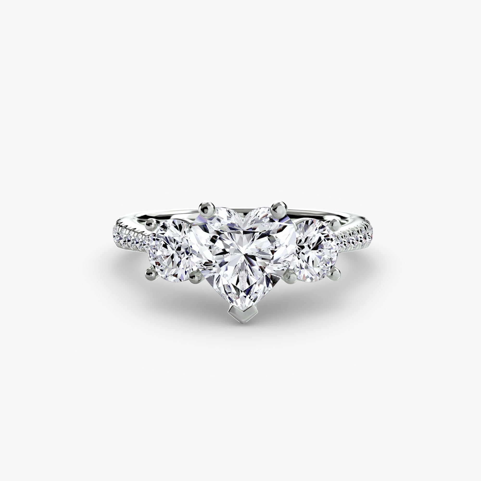 The MICHAEL ISAAC Three-Stone with Pavé Band ring showcases a heart-shaped center diamond and two round side diamonds, accented by pavé stones, all set in silver and displayed on a plain white background.