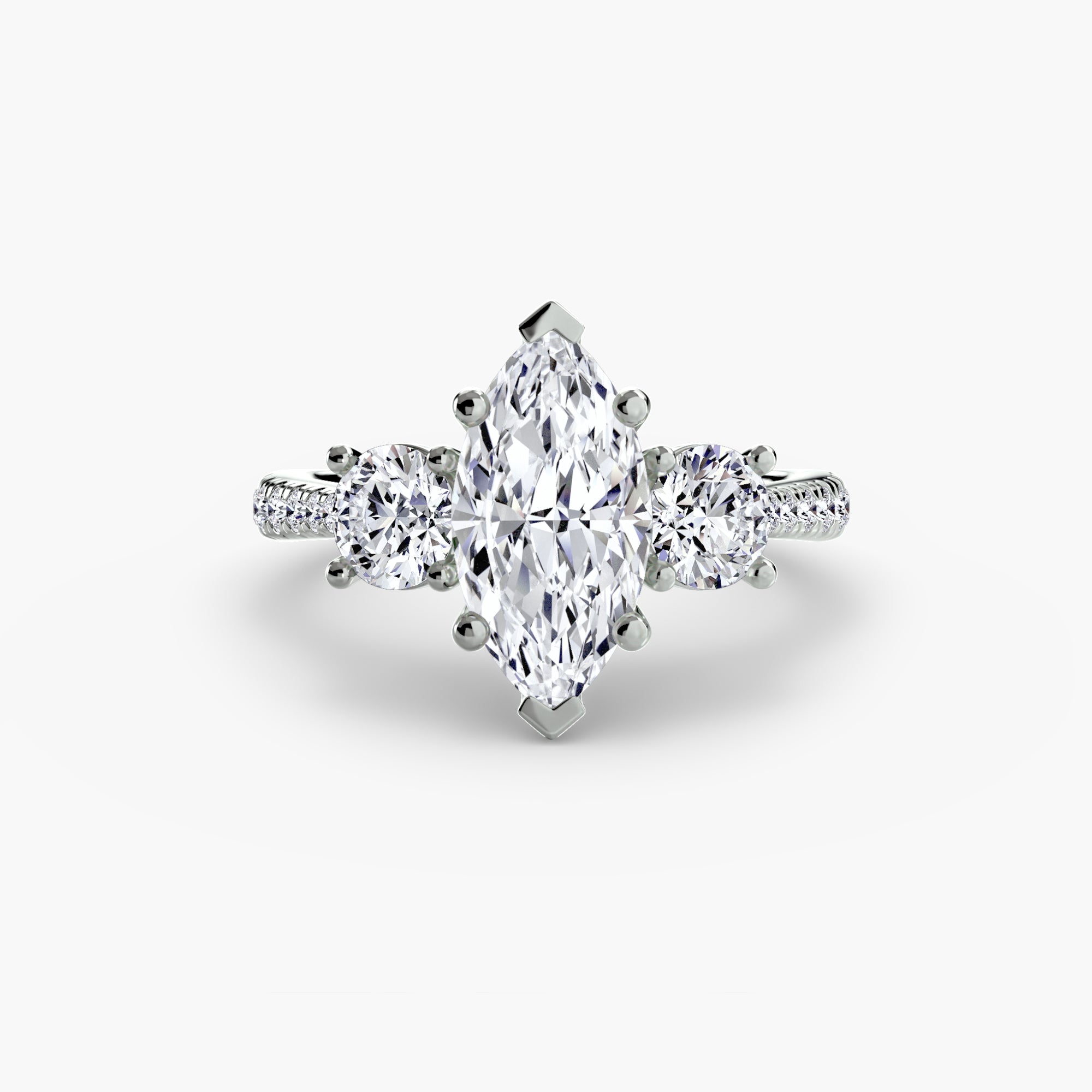 The MICHAEL ISAAC Three-Stone with Pavé Band is a white gold engagement ring featuring a marquise-cut center diamond, two round side diamonds, and a pavé band sparkling with accent stones.