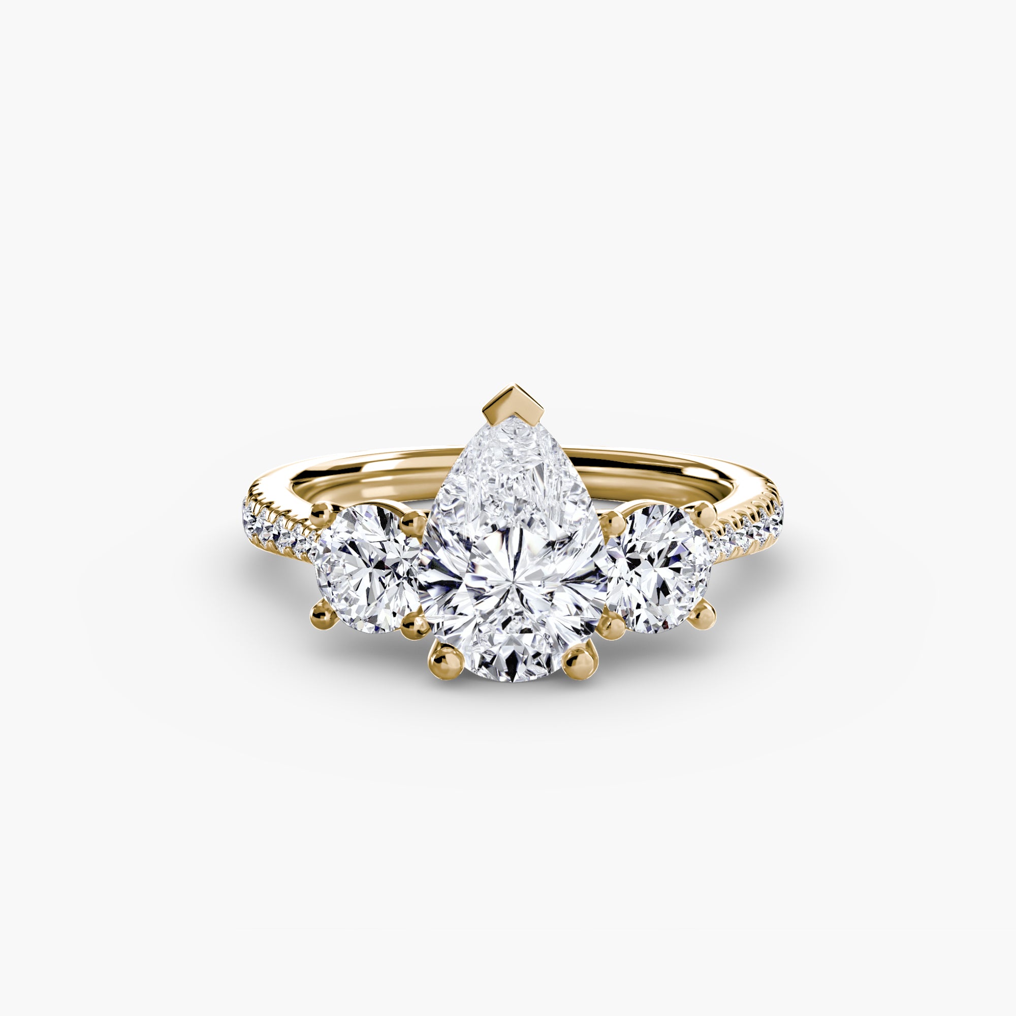 The MICHAEL ISAAC Three-Stone with Pavé Band ring showcases a central pear-shaped diamond, two round side diamonds, and pavé-set diamonds along the band for added brilliance.