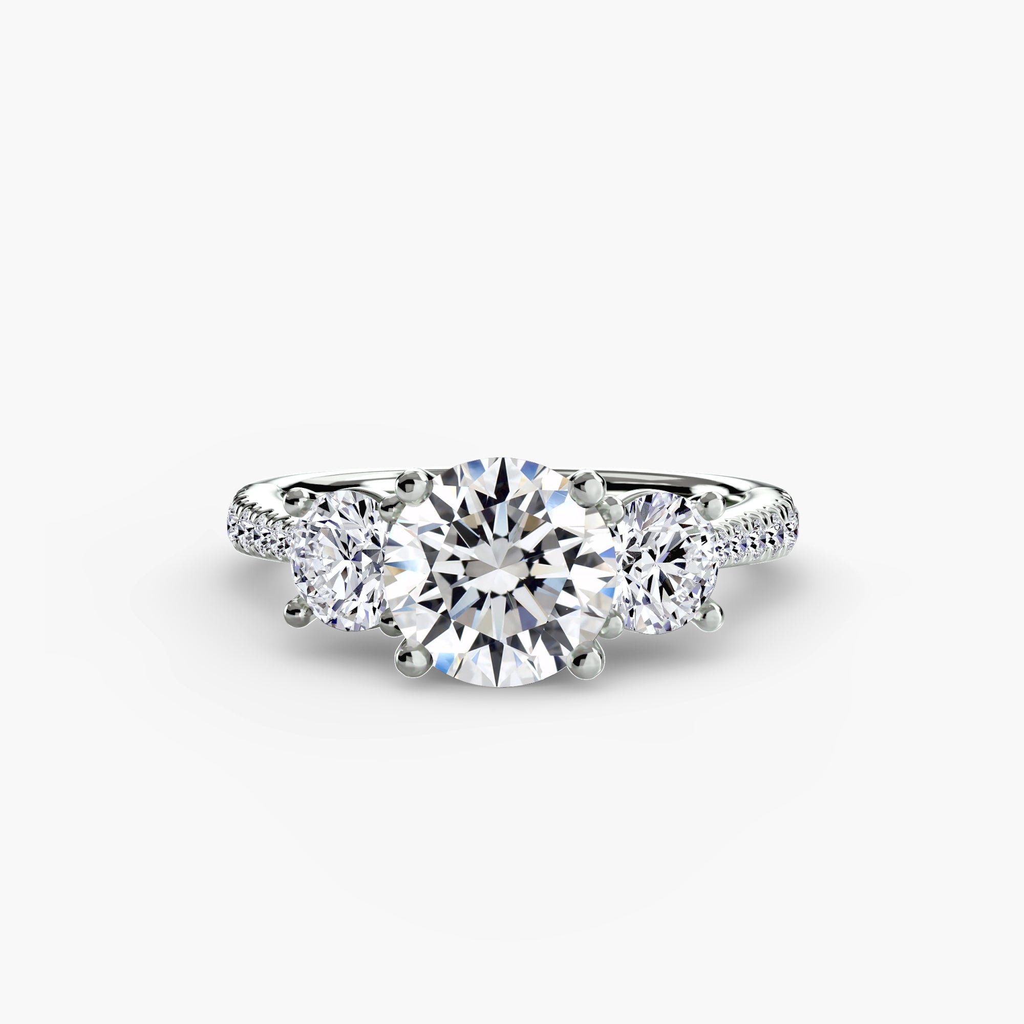 The MICHAEL ISAAC Three-Stone with Pavé Band is a white gold ring featuring a large round center diamond, two side diamonds, and sparkling pavé-set accents along the band.