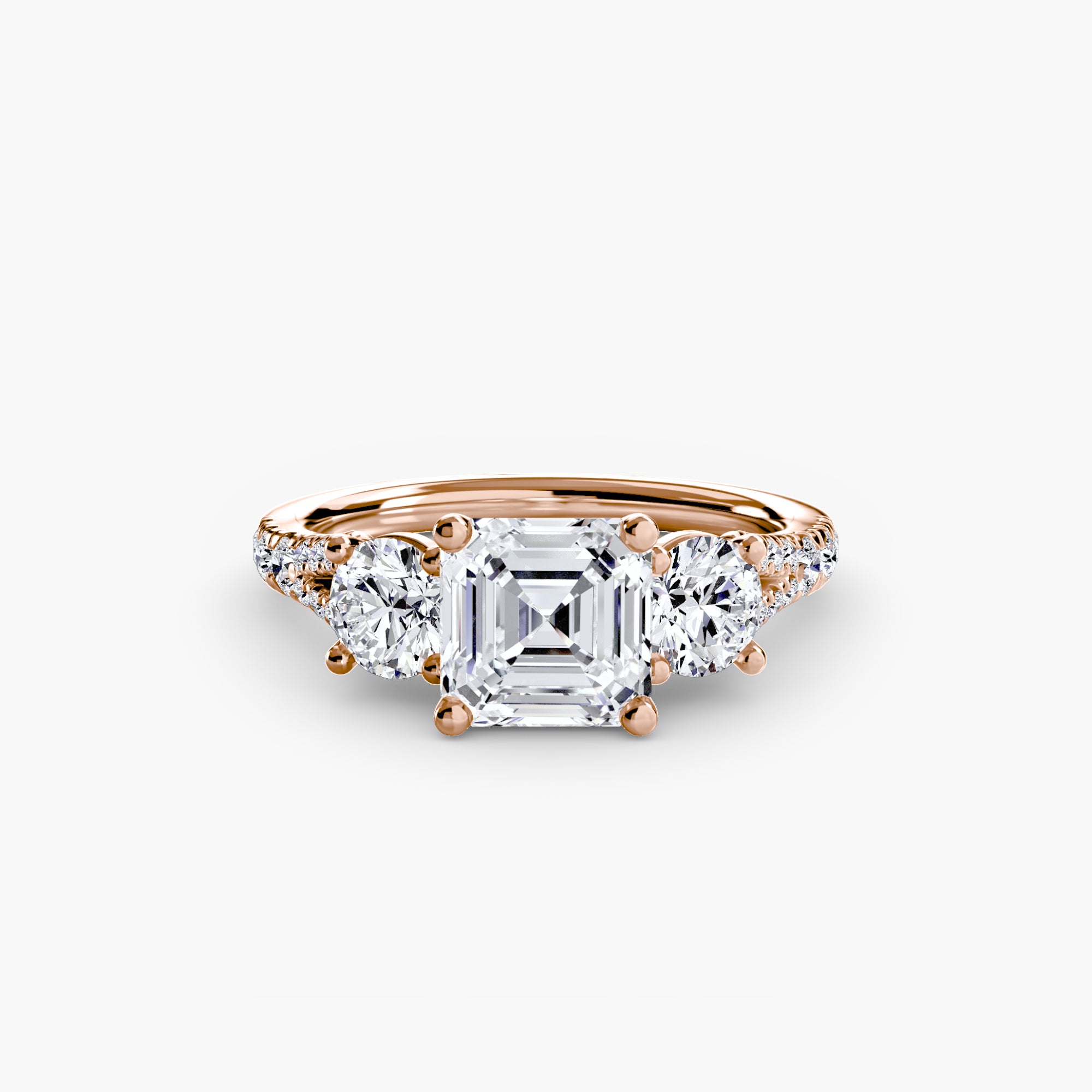 The MICHAEL ISAAC Three-Stone with Pavé Band 3 is a rose gold ring with a square-cut center diamond, two round side diamonds, and an elegant pavé band, shown on a plain white background.