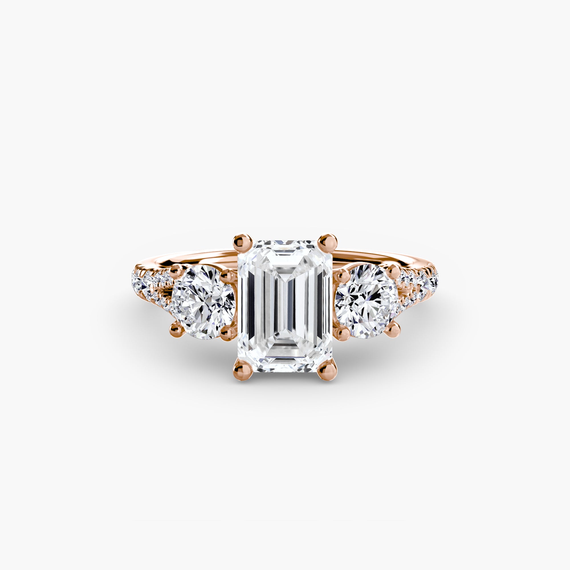 The MICHAEL ISAAC Three-Stone with Pavé Band 3 ring features a large emerald-cut diamond center flanked by round diamonds and pavé accents, shown on a plain white background.
