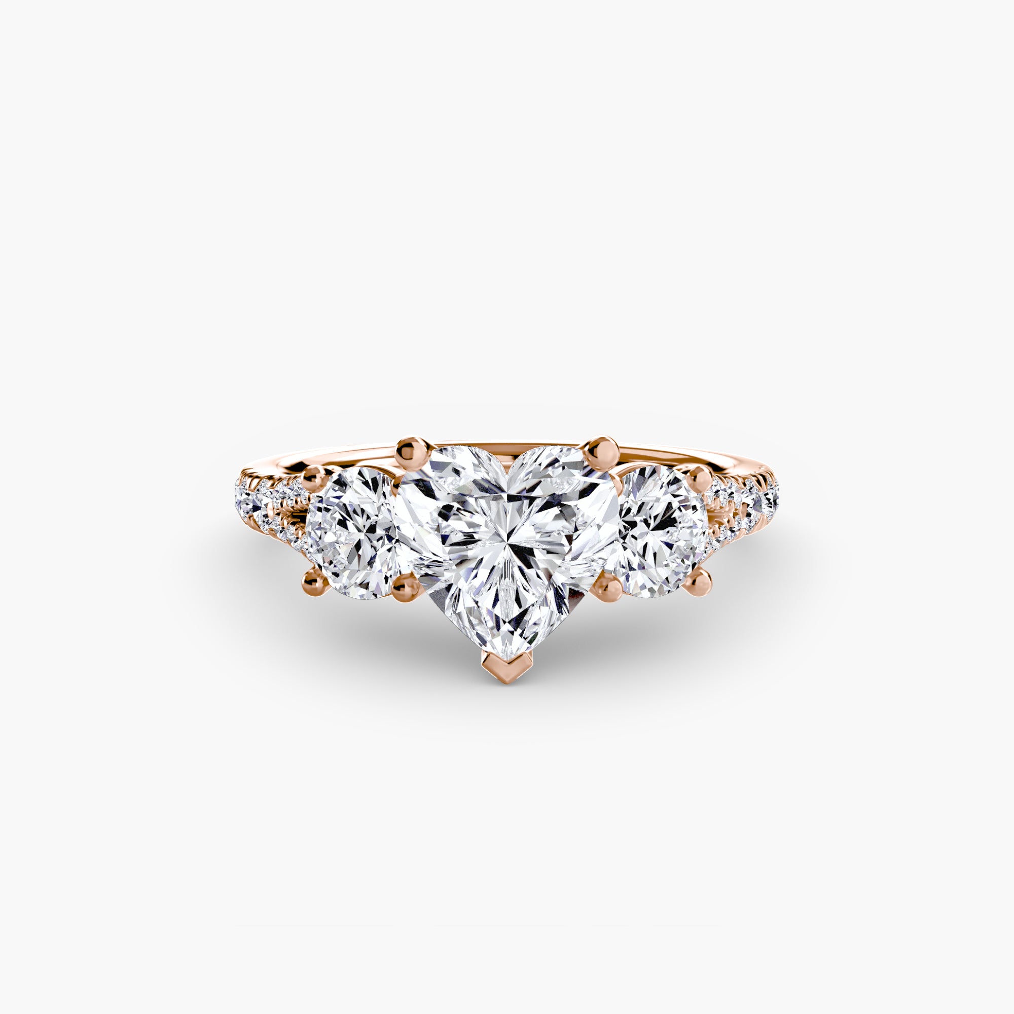The MICHAEL ISAAC Three-Stone with Pavé Band 3 features a heart-shaped diamond center, side stones, and pavé diamonds on the band, elegantly showcased against a plain white background.