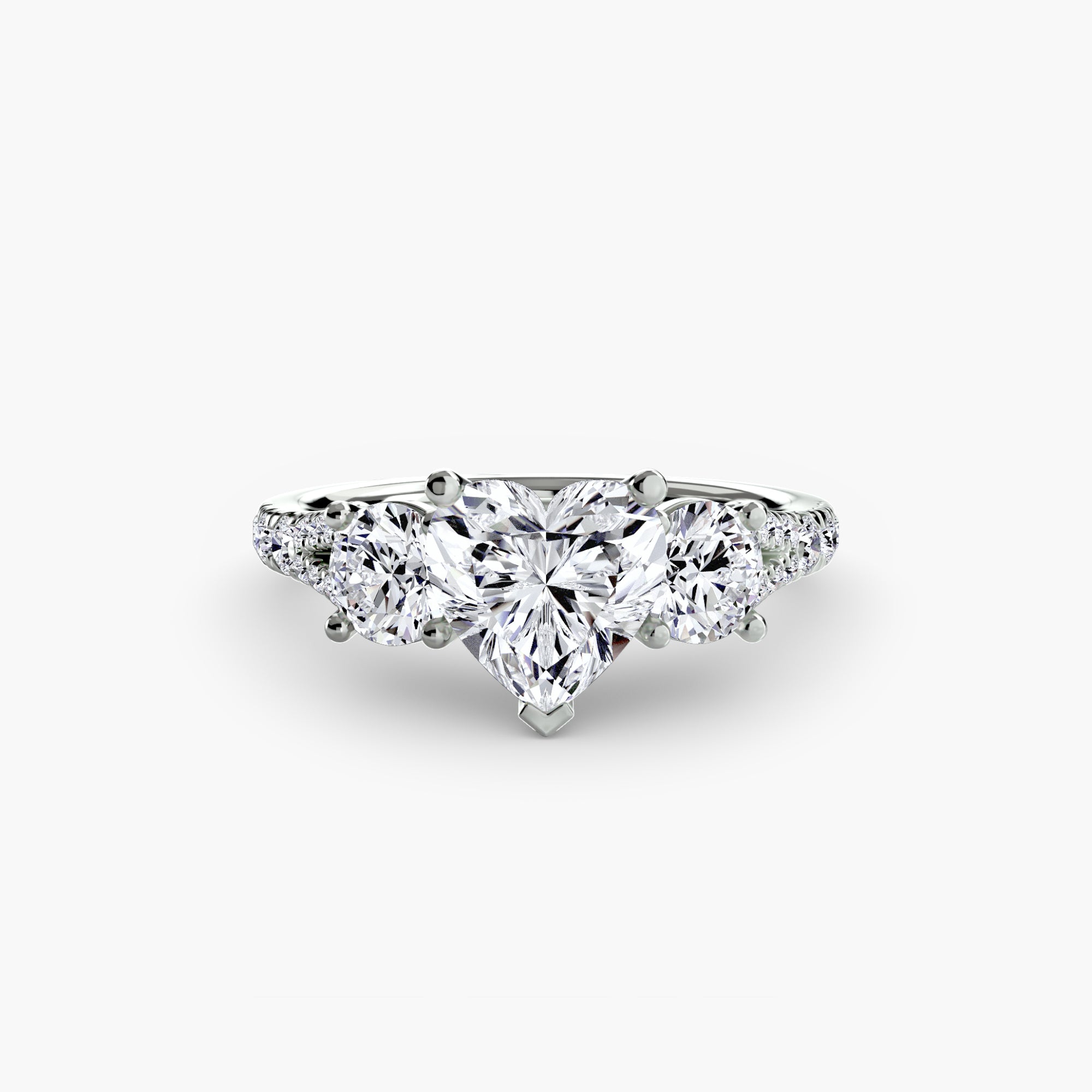 The MICHAEL ISAAC Three-Stone with Pavé Band 3 showcases a heart-shaped center diamond, two pear-shaped side diamonds, and round accent stones set in white gold, displayed against a plain white background.