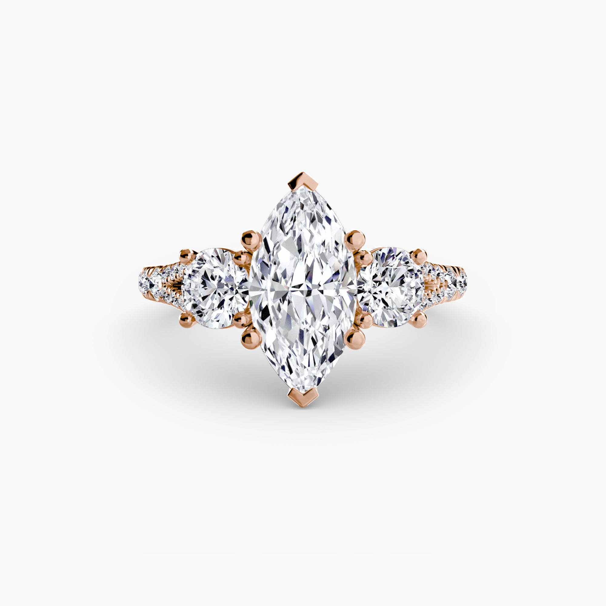 The MICHAEL ISAAC Three-Stone with Pavé Band 3 ring features a marquise-cut diamond, two round side diamonds, and accent stones on a rose gold pavé band, shown against a white background.