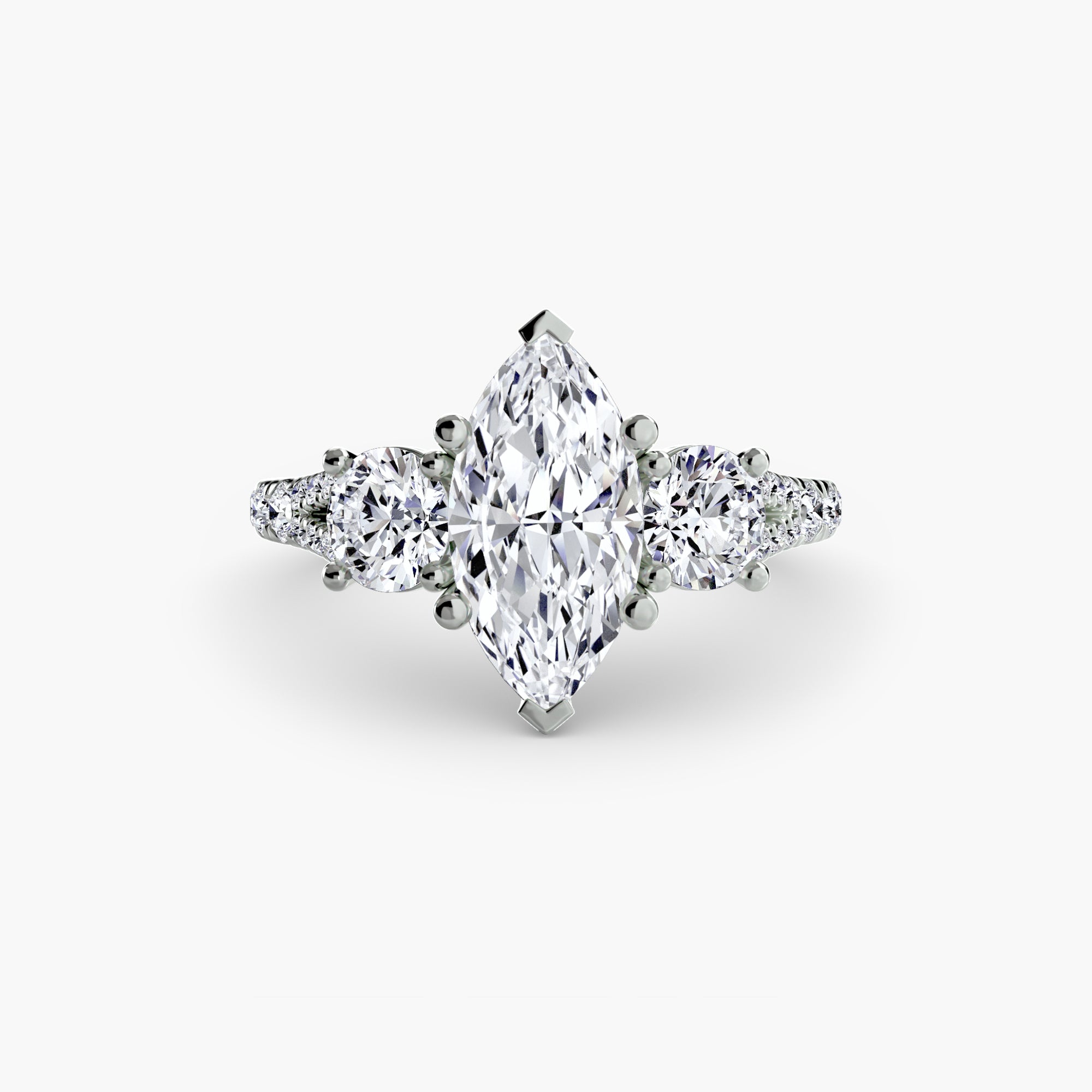 The MICHAEL ISAAC Three-Stone with Pavé Band 3 is a white gold ring with a large marquise-cut center diamond, two pear-shaped side diamonds, and round pavé band diamonds, displayed on a plain white background.