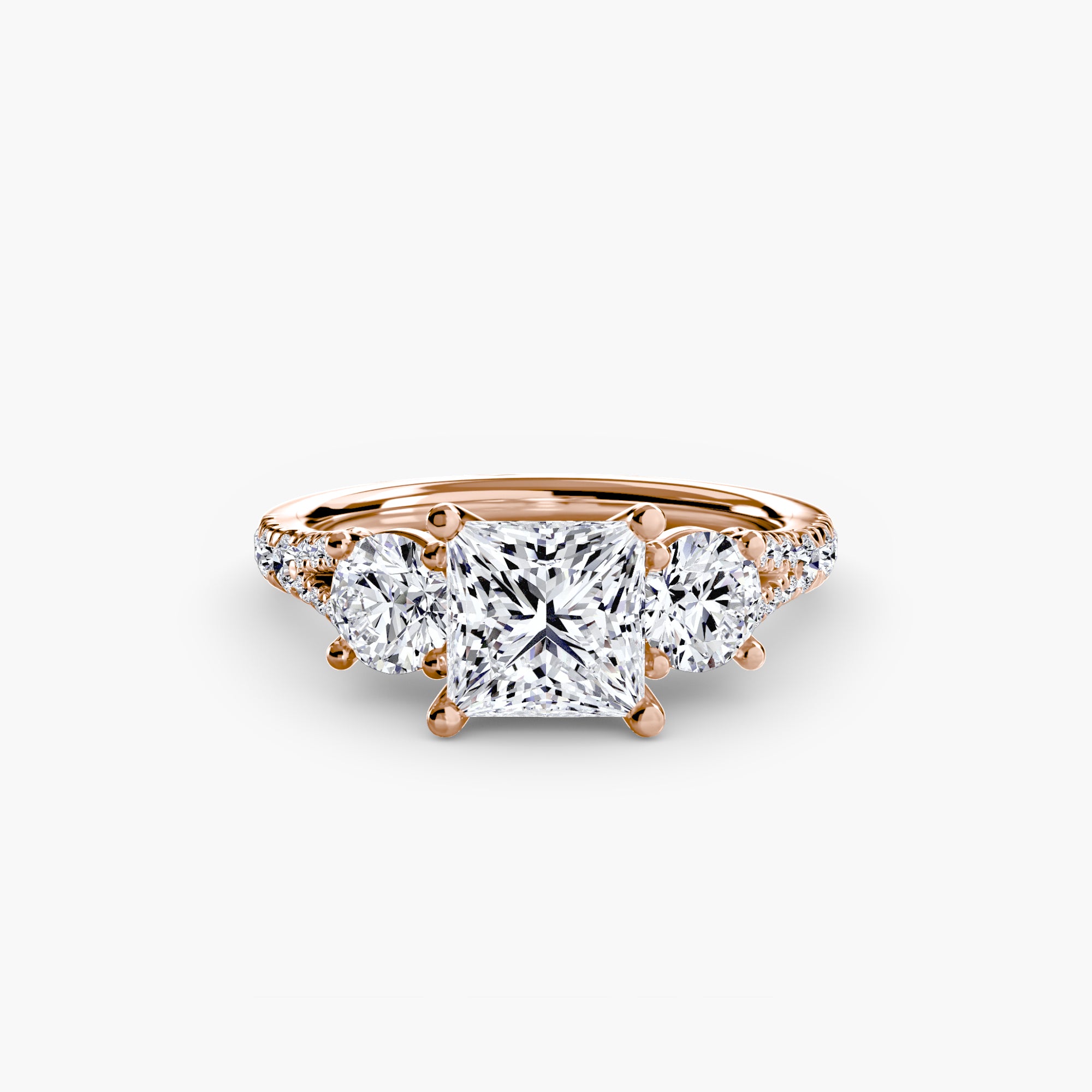 The MICHAEL ISAAC Three-Stone with Pavé Band 3 ring in rose gold features a square-cut center diamond, two round side diamonds, and a pavé diamond band, shown against a plain white background.