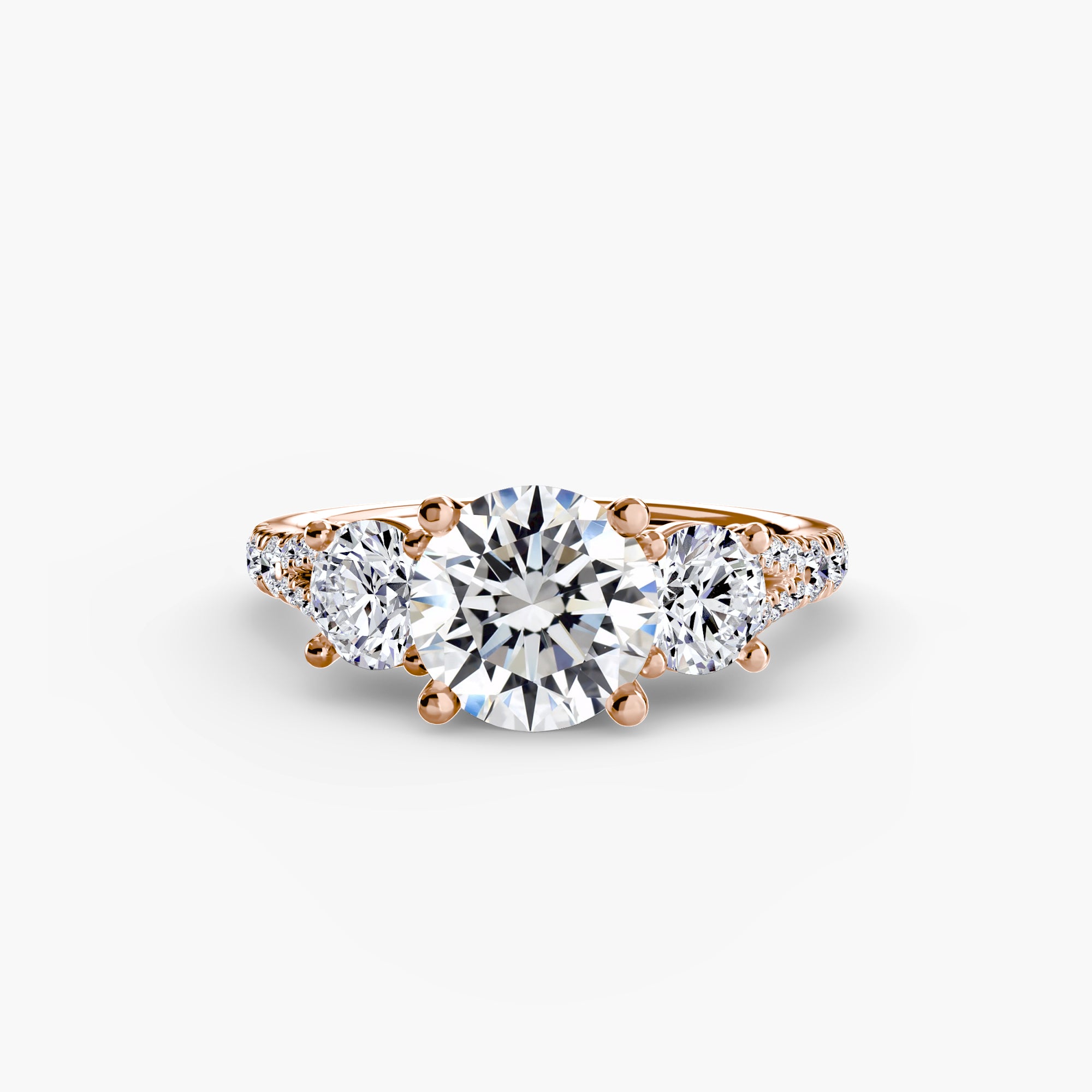 The MICHAEL ISAAC Three-Stone with Pavé Band 3 is a rose gold ring with a large round diamond center, two smaller side diamonds, and a pavé band, displayed on a plain white background.