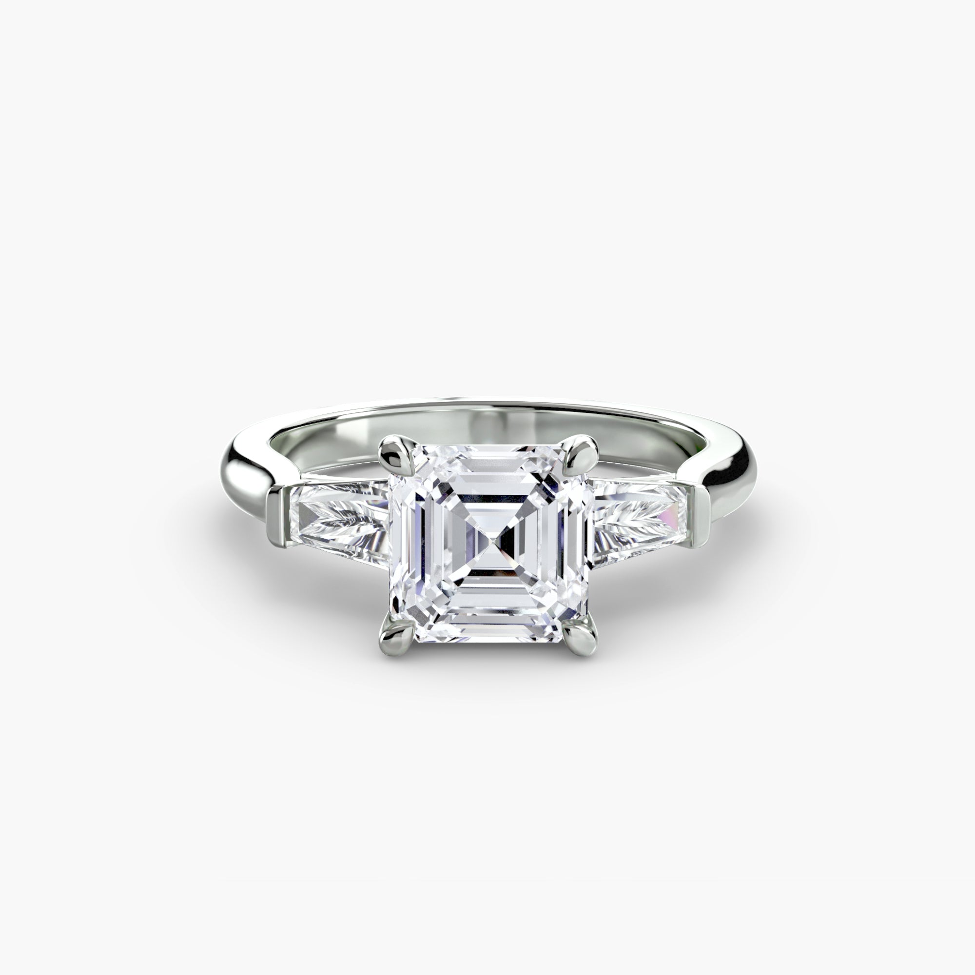 The MICHAEL ISAAC Three-Stone Ring (Baguette Side Stones) features a large square-cut center diamond with two rectangular baguette side stones, showcased against a plain white background.