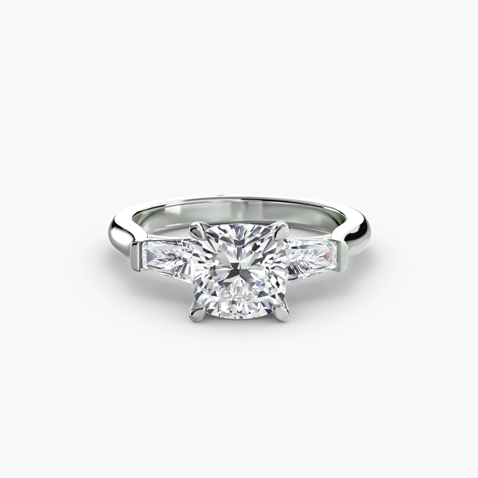 A MICHAEL ISAAC Three-Stone Ring with a cushion-cut diamond center and baguette side stones is displayed on a white background.