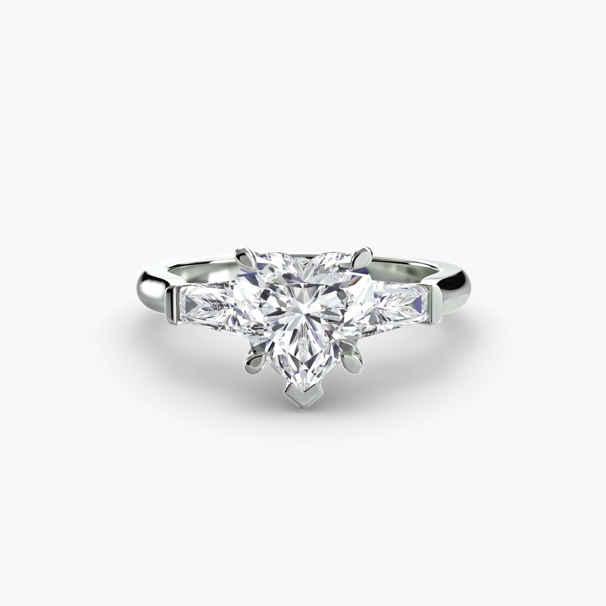 The MICHAEL ISAAC Three-Stone Ring features a central diamond with two baguette side stones, all set in silver. Photographed against a plain white background, the ring highlights its elegant and timeless three-stone design.