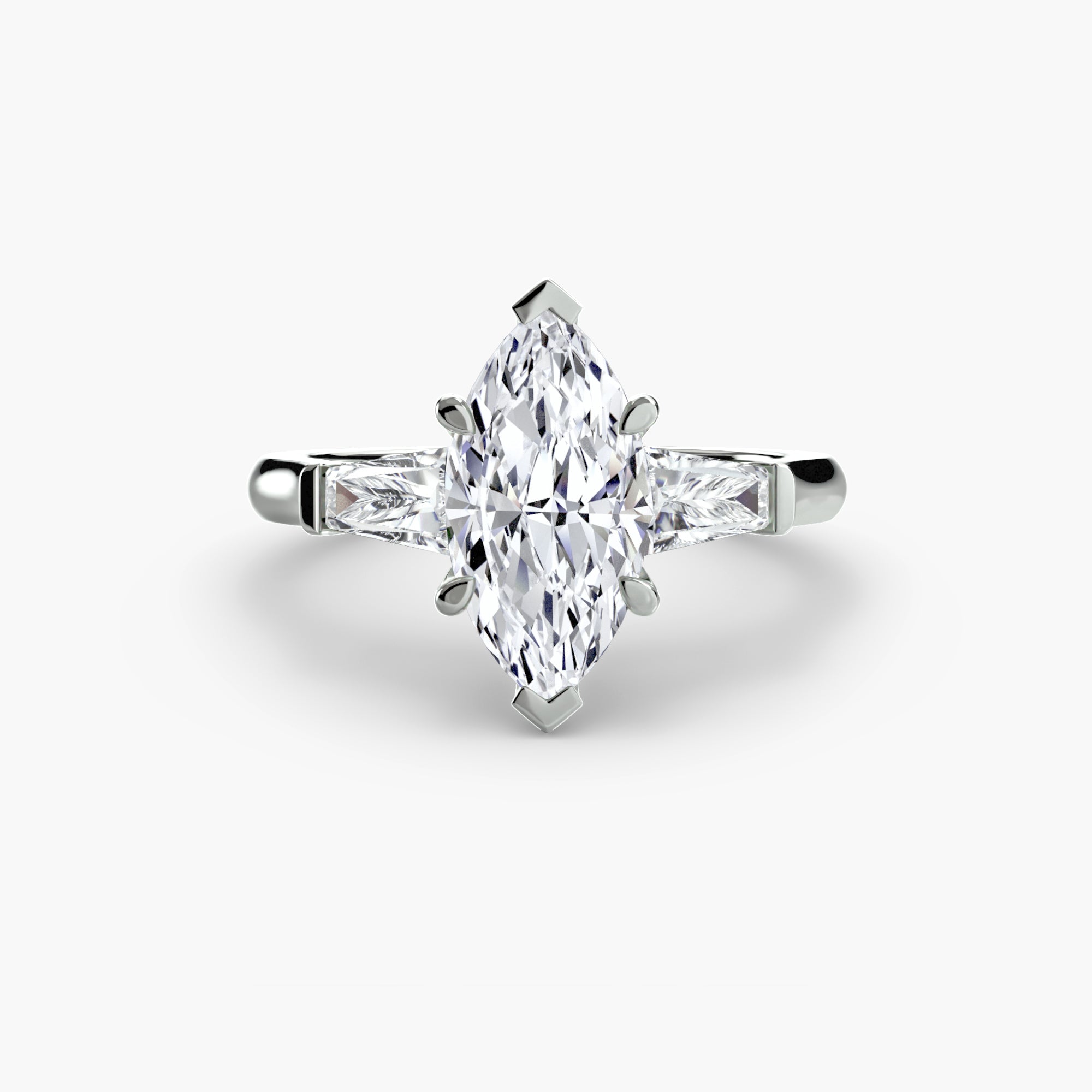 The MICHAEL ISAAC Three-Stone Ring features a silver design with a large marquise-cut diamond at the center and baguette side stones, showcased on a plain white background.