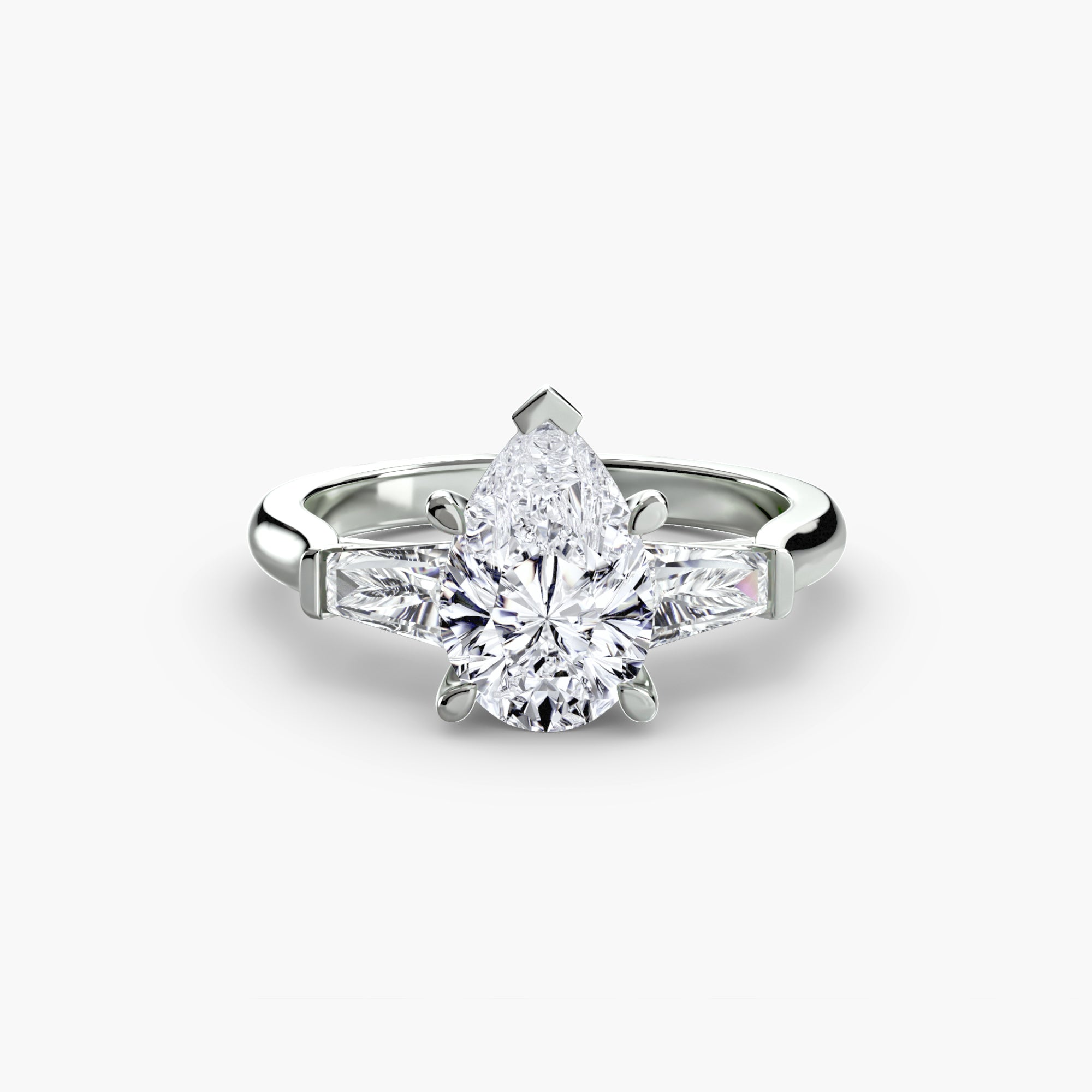 The MICHAEL ISAAC Three-Stone Ring features a white gold band with a pear-shaped center diamond and baguette side stones, shown against a plain white background.
