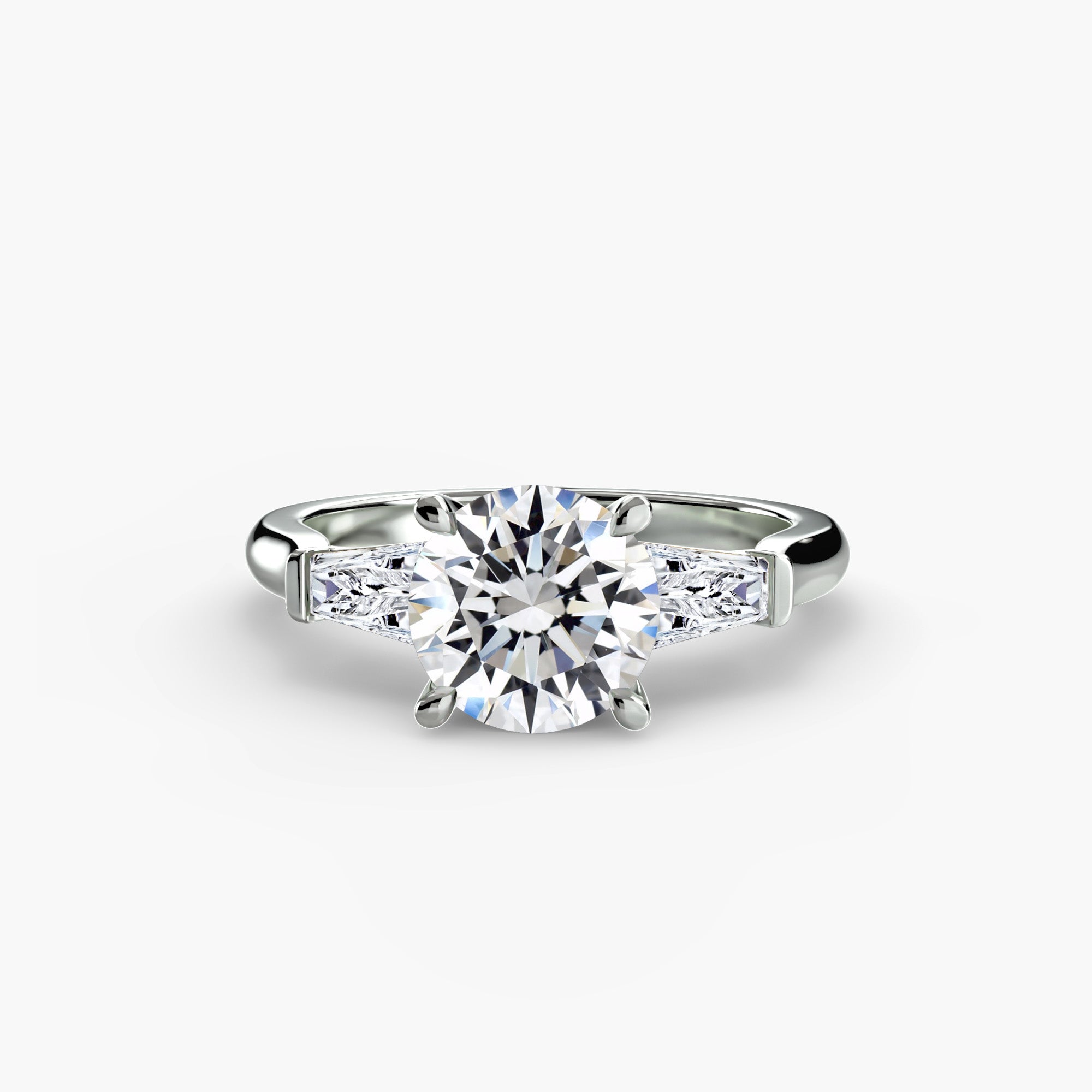 The MICHAEL ISAAC Three-Stone Ring features a large round center diamond with baguette side stones, crafted in white gold or platinum, and is shown against a plain white background.