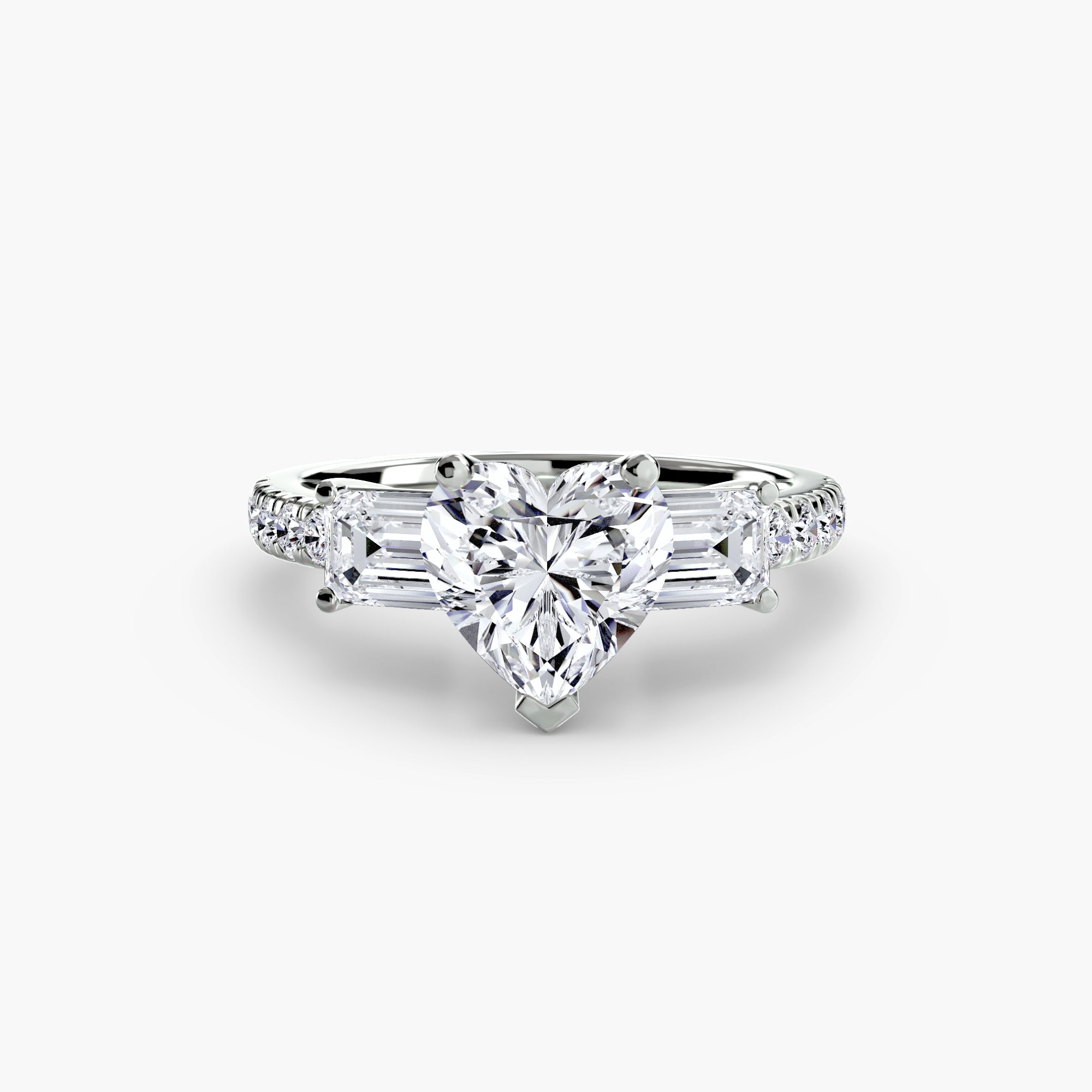 The MICHAEL ISAAC Three-Stone Ring with Pavé Band 4 showcases a large heart-shaped center diamond, two rectangular side diamonds, and a pavé-set white gold band, all elegantly displayed against a plain white background.