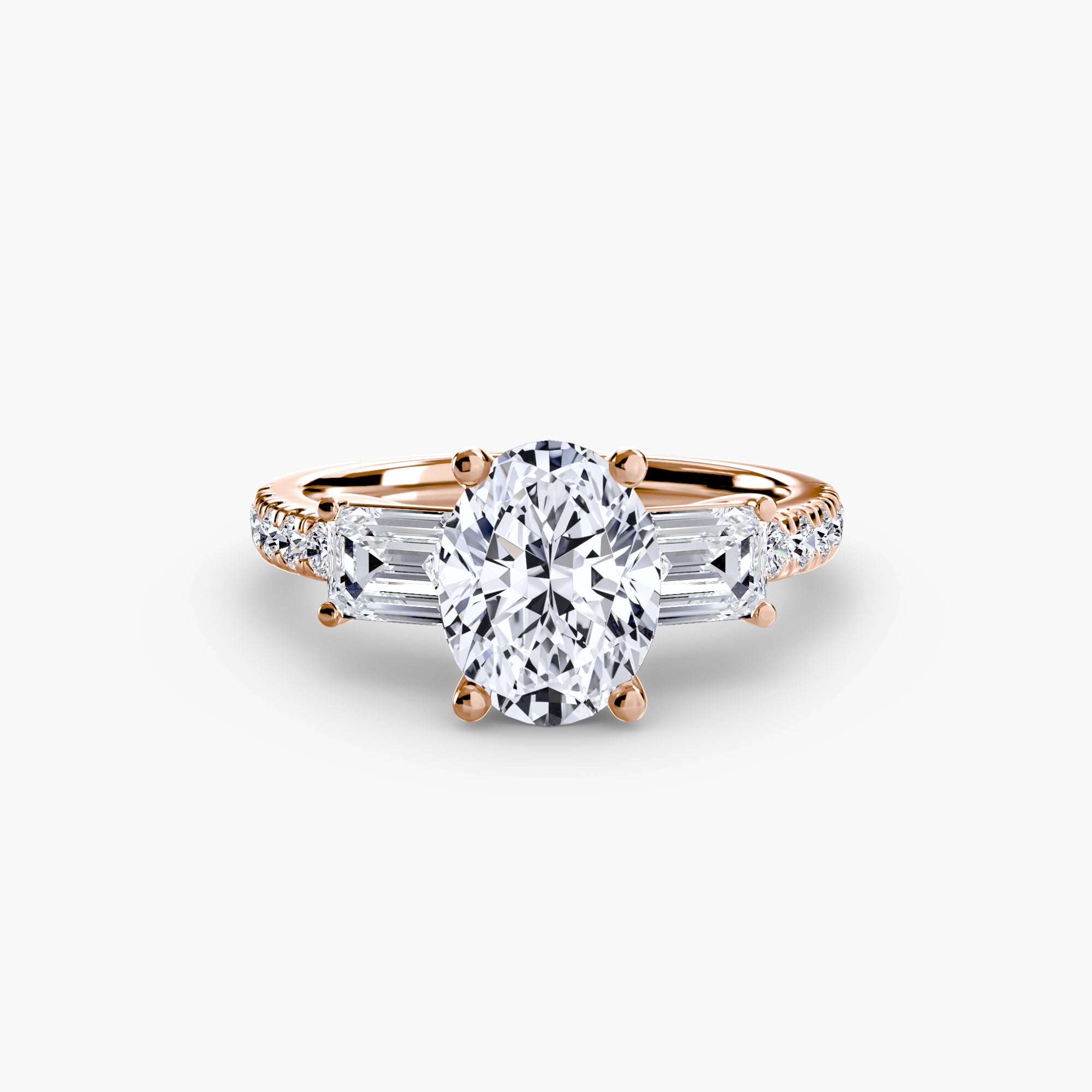 The MICHAEL ISAAC Three-Stone Ring with Pavé Band 4 features a rose gold setting with an oval-cut center diamond, two tapered baguette side diamonds, and pavé round diamonds on the band, shown against a white background.